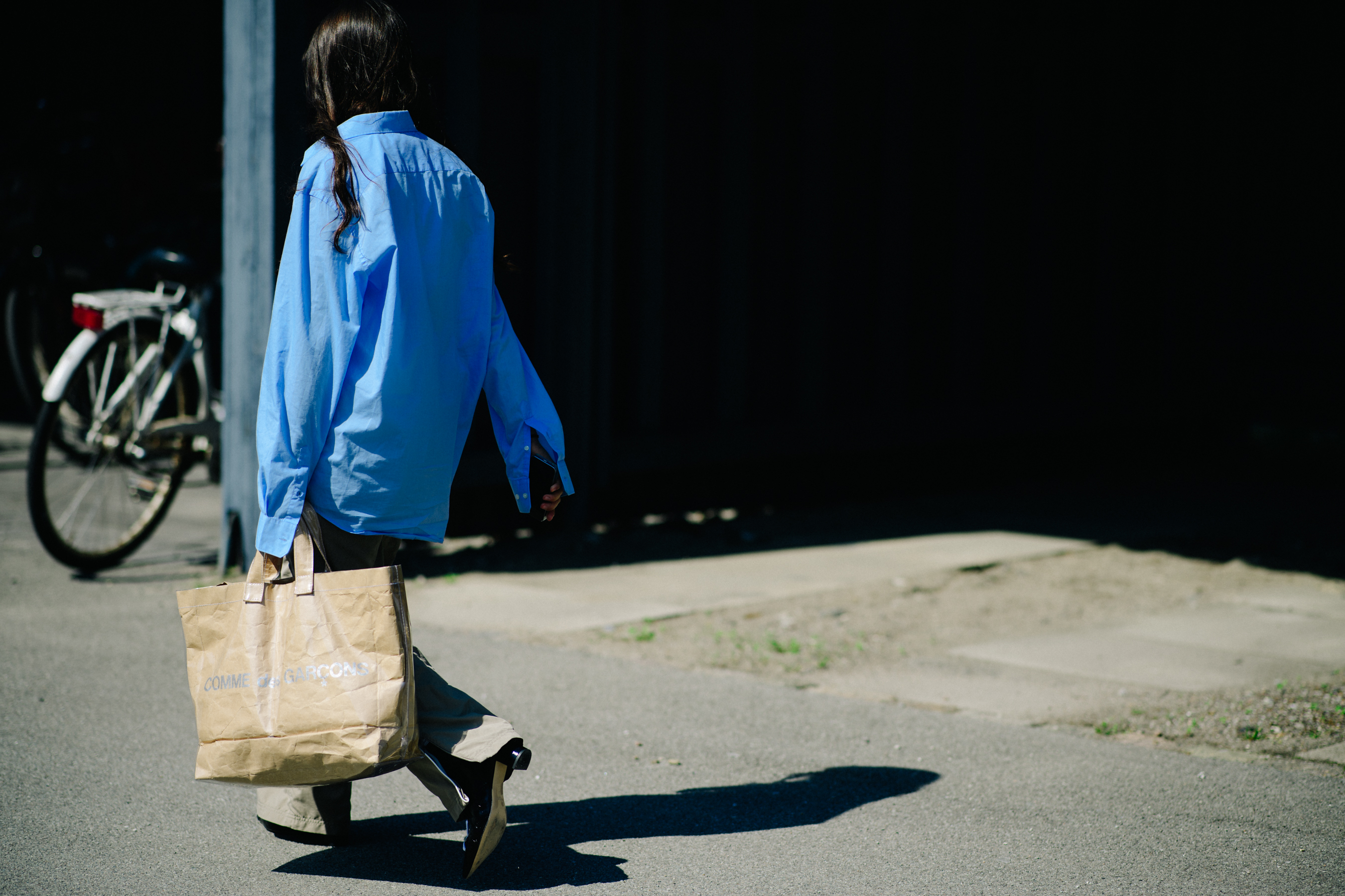 Woman wearing Comme Des Garcons bag