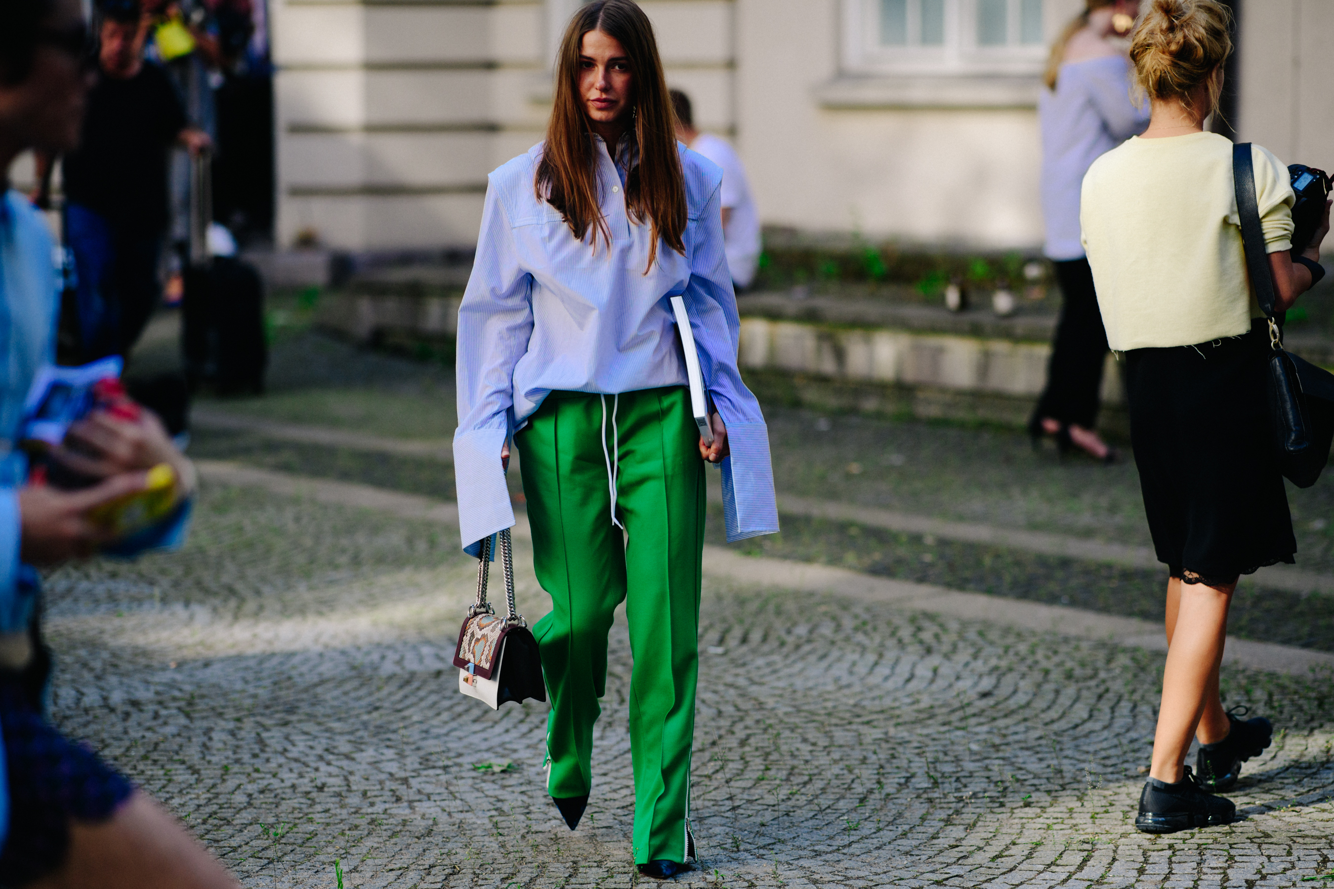 Woman wearing oversized shirt and green pants