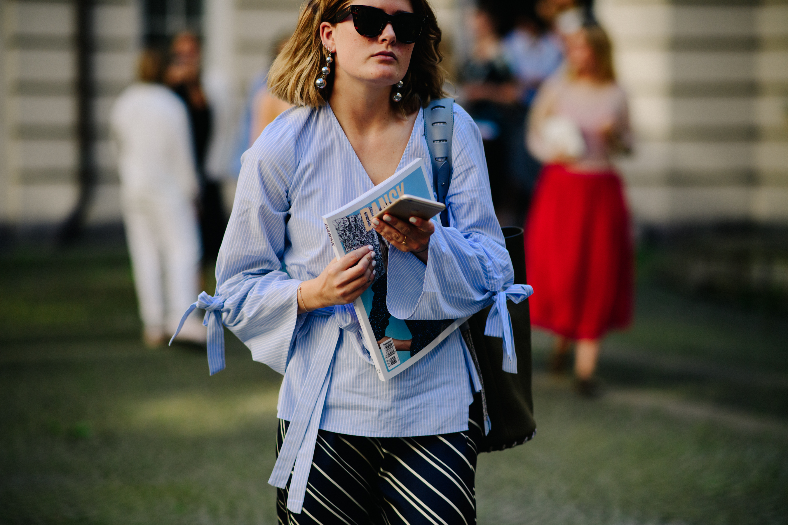 Woman wearing belted shirt and glasses