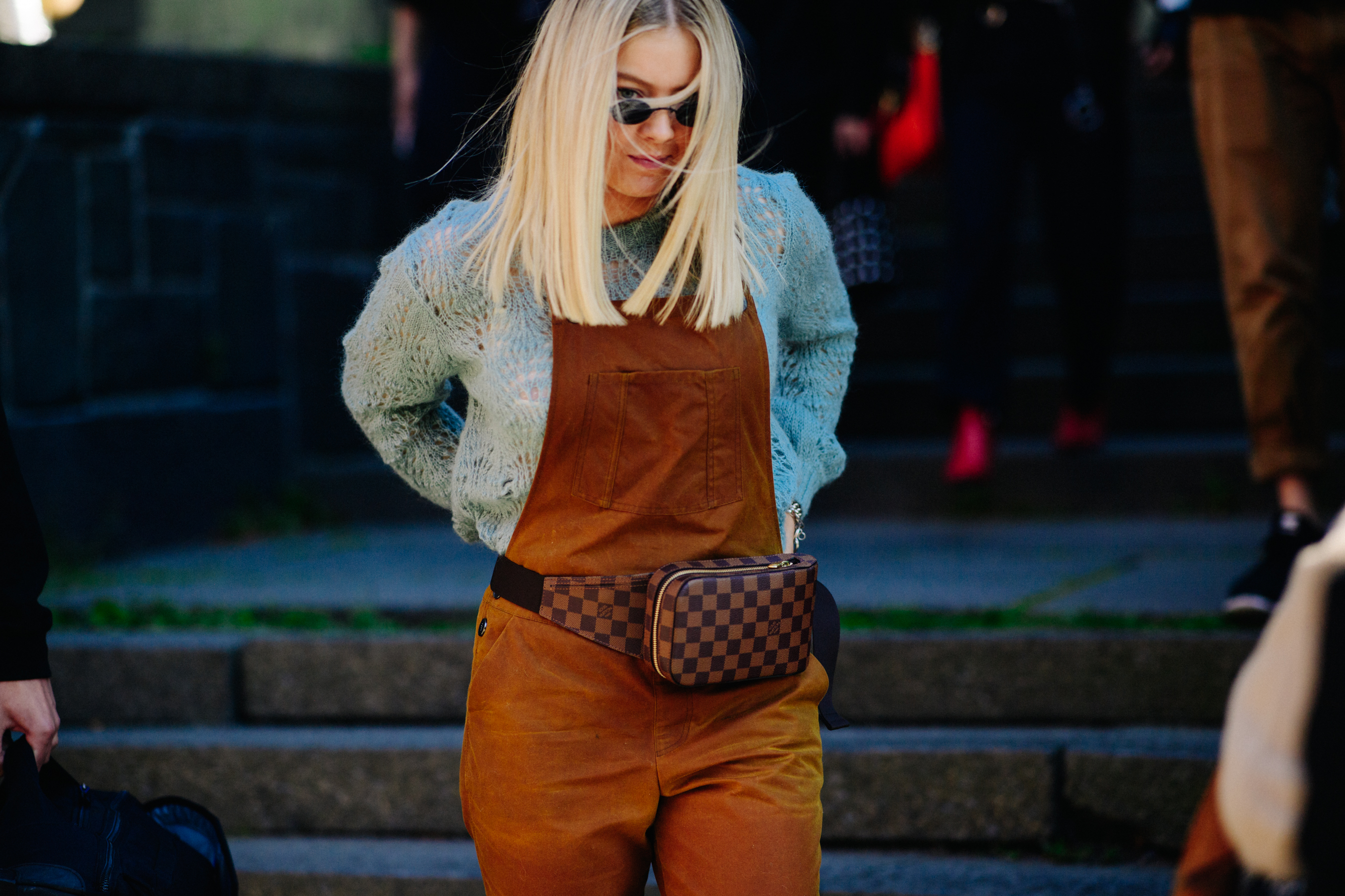 Woman wearing Louis Vuitton pouch