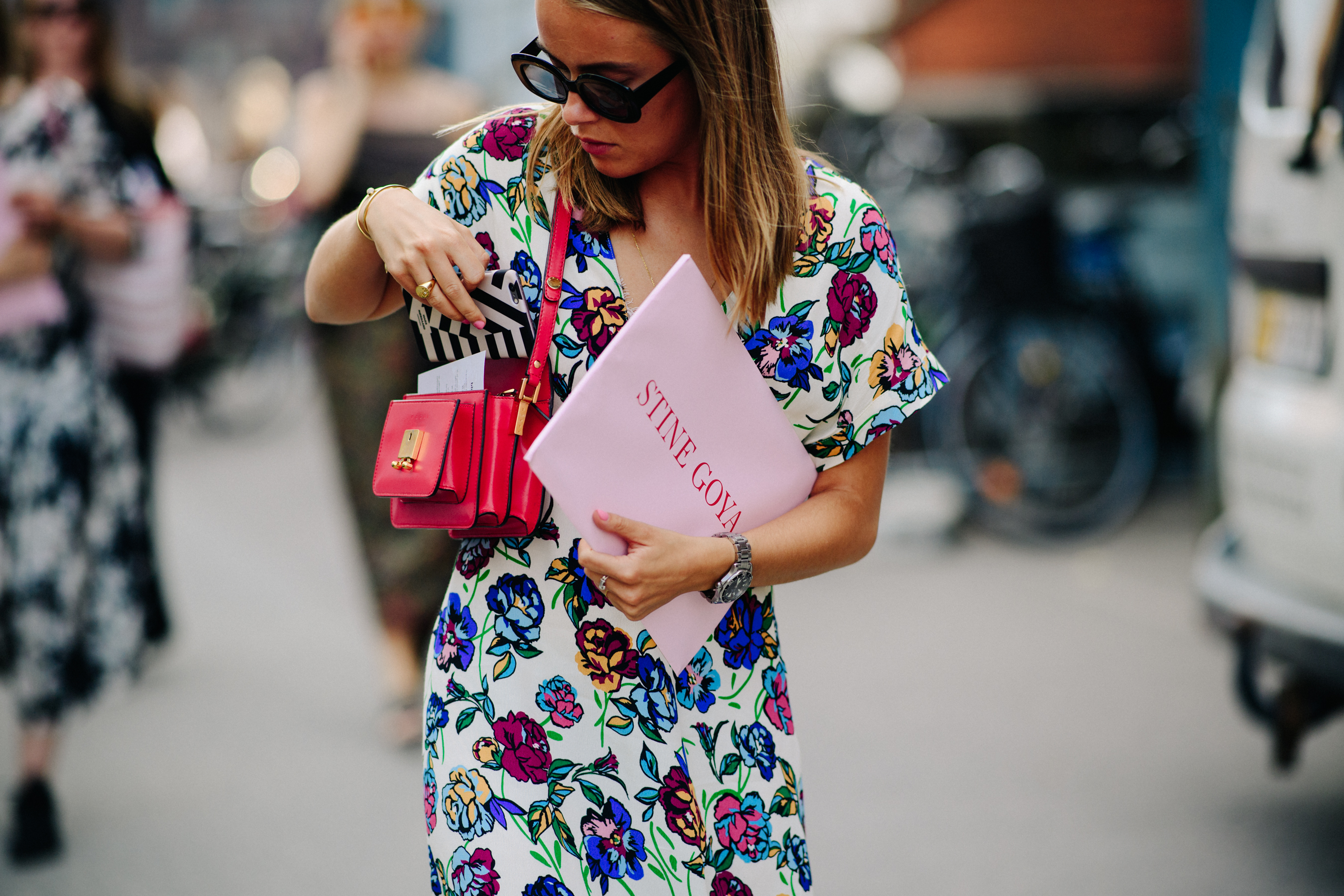 Woman wearing red bag and dress