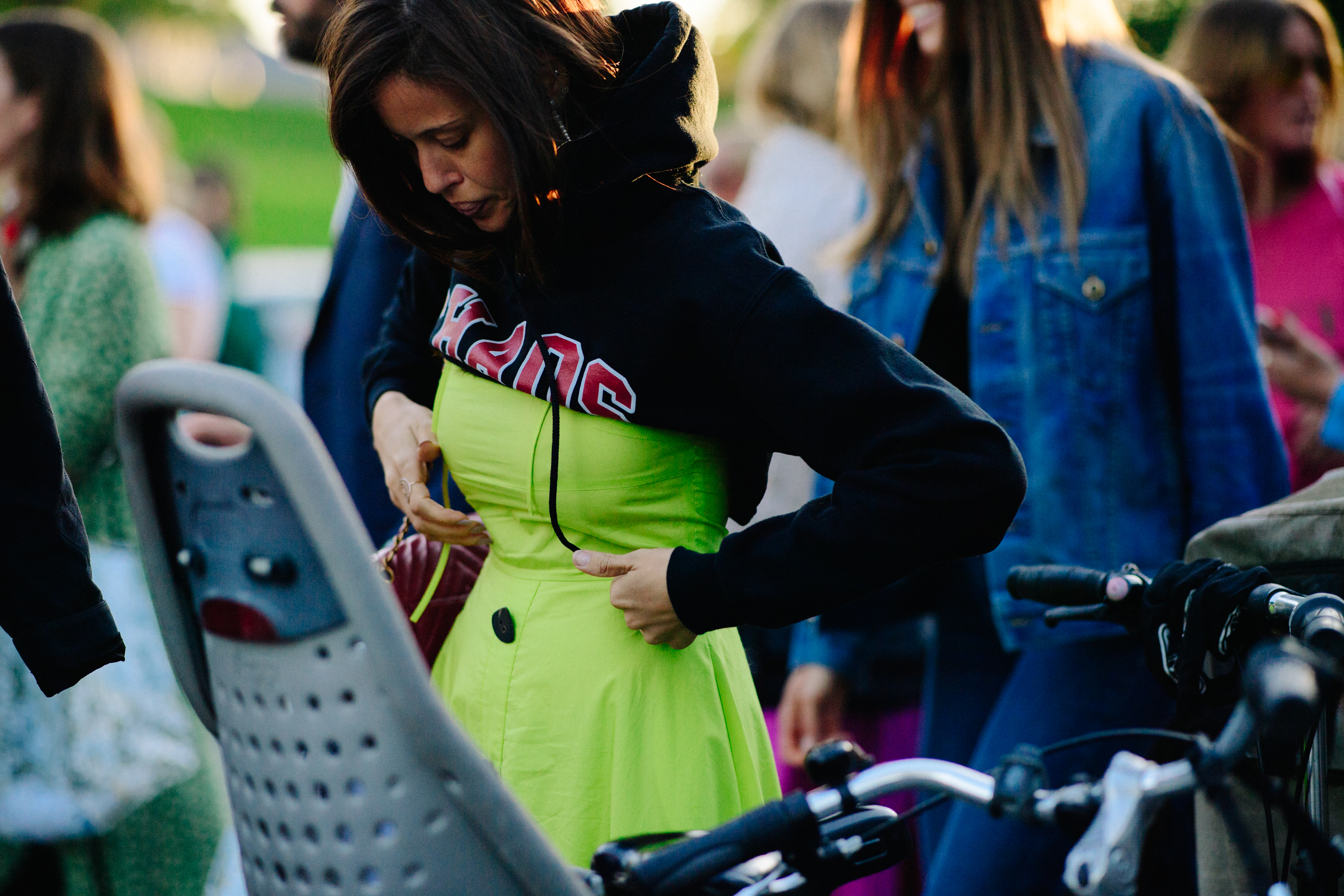 Woman wearing yellow dress and hoodie