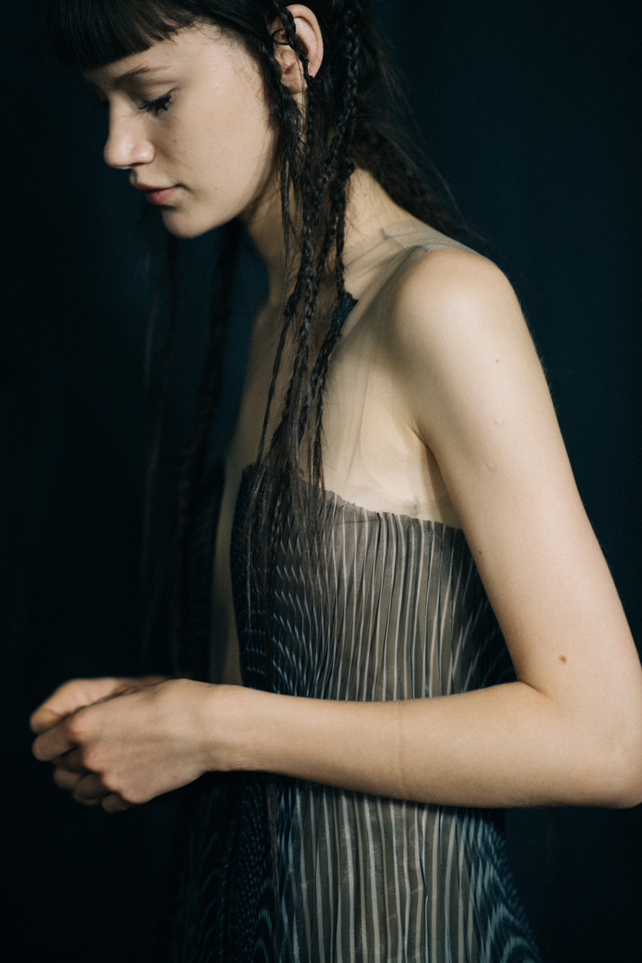 Model wearing sheer dress before a show