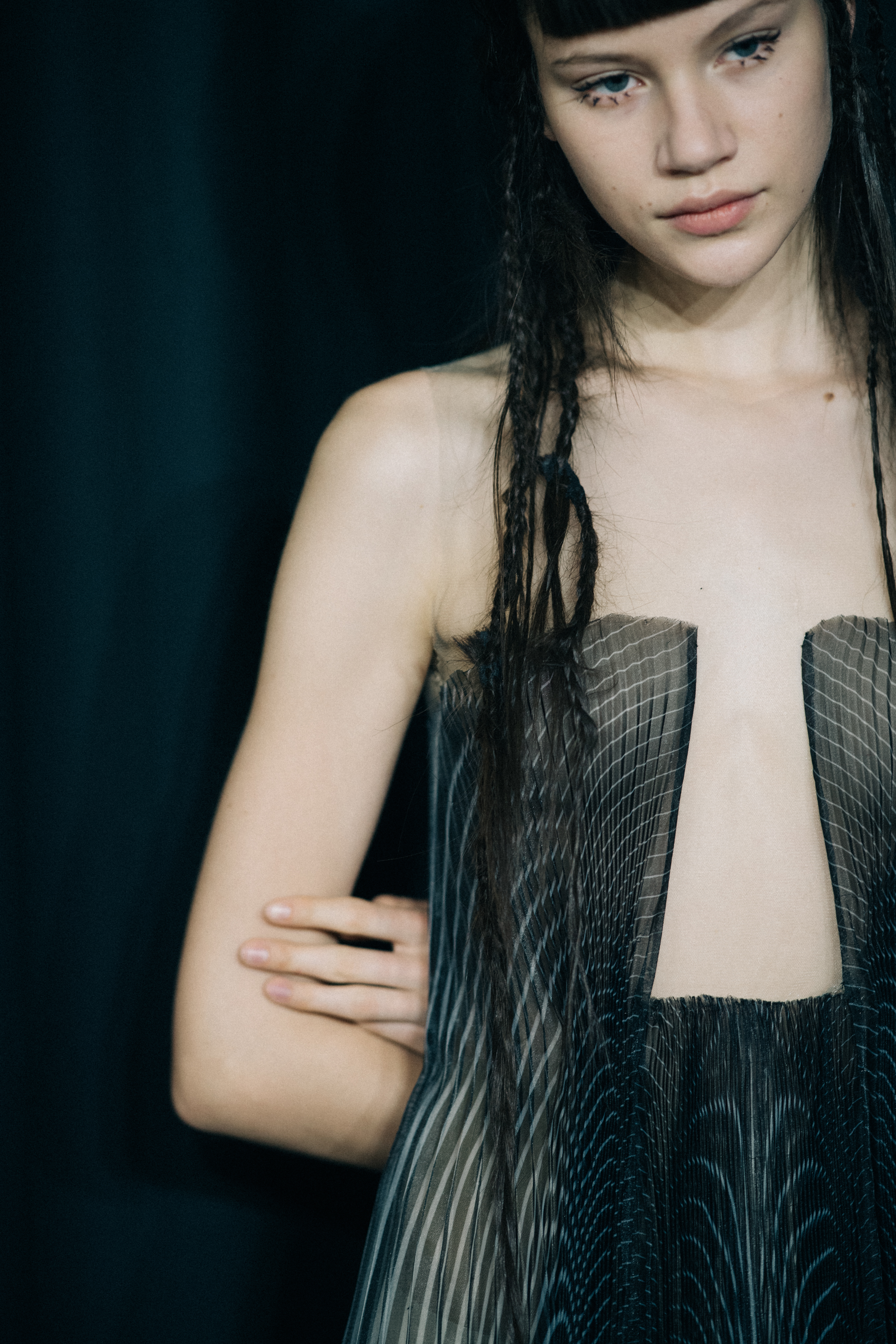Model wearing sheer dress before a show