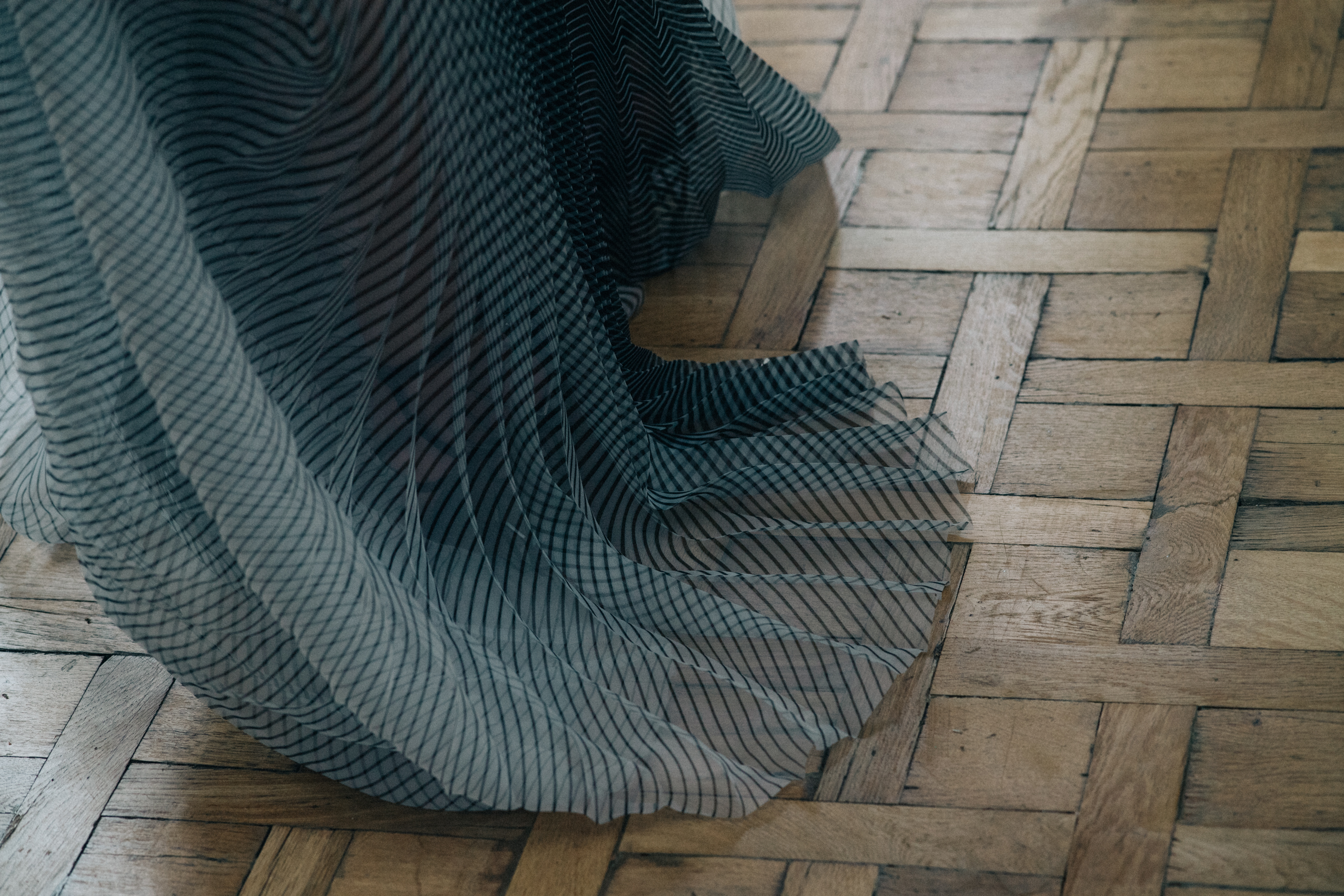 Model wearing complex fabric dress