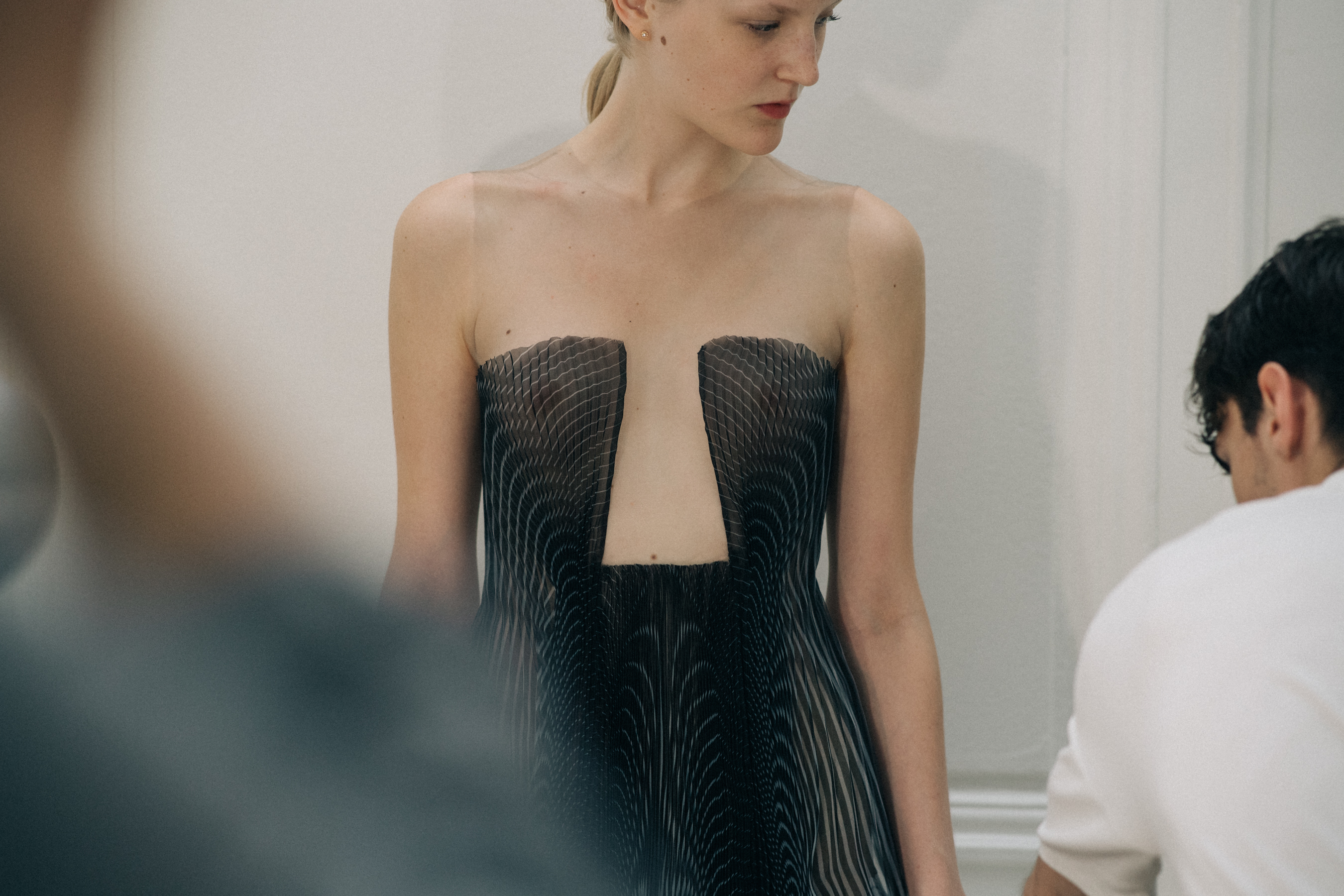 Model wearing sheer fabric dress