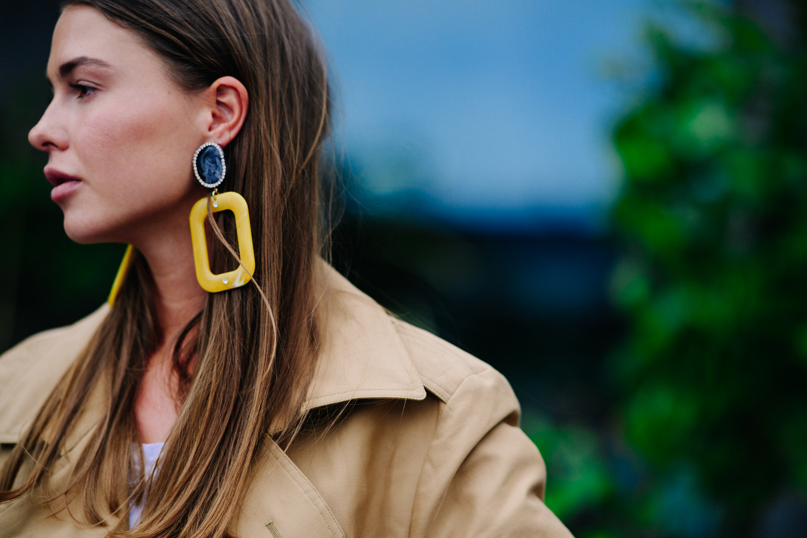 Woman wearing beige coat and earring