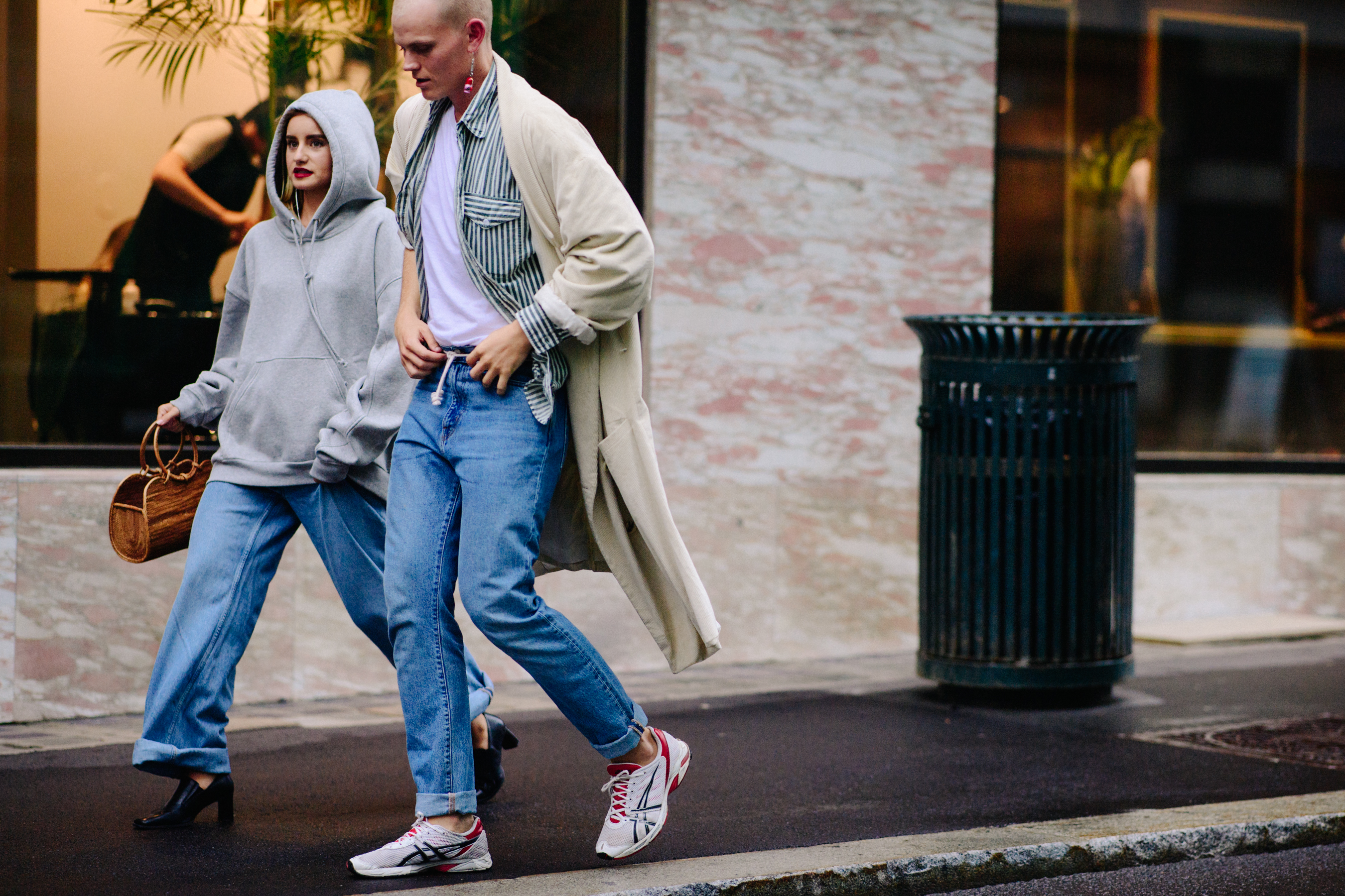 Man and woman wearing hoodie and trench