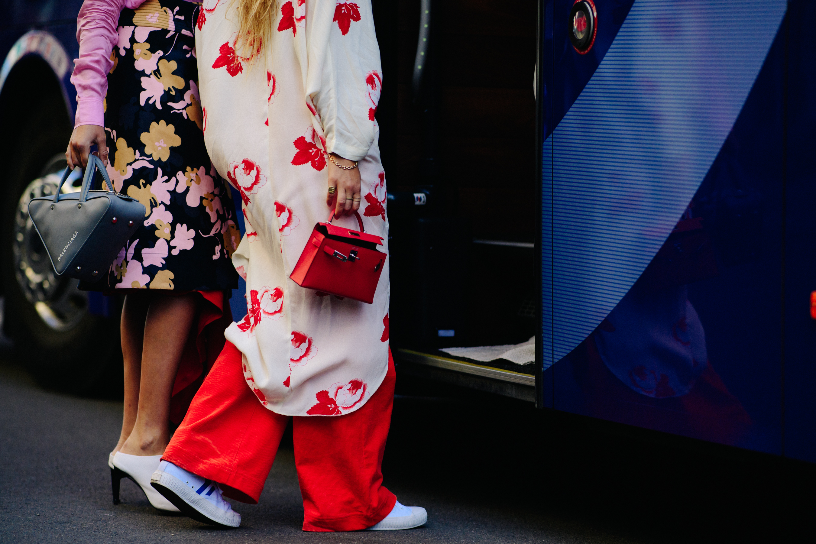 Two women wearing balenciaga bags