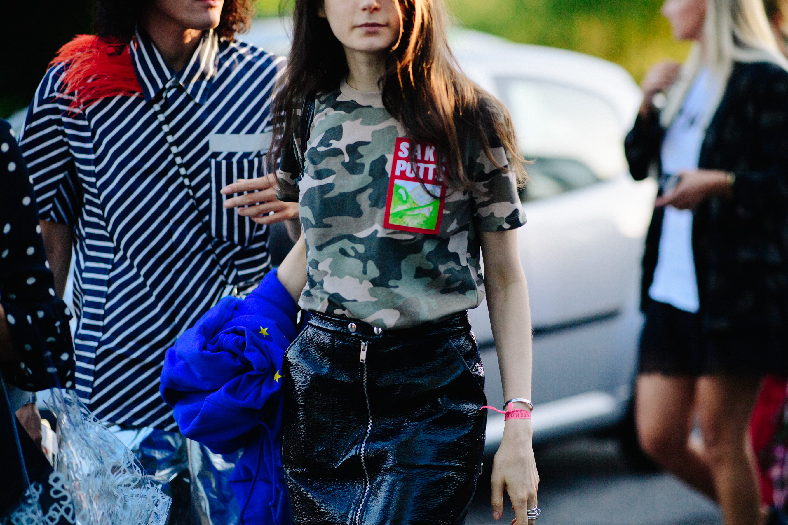 Woman wearing leather skirt and camo