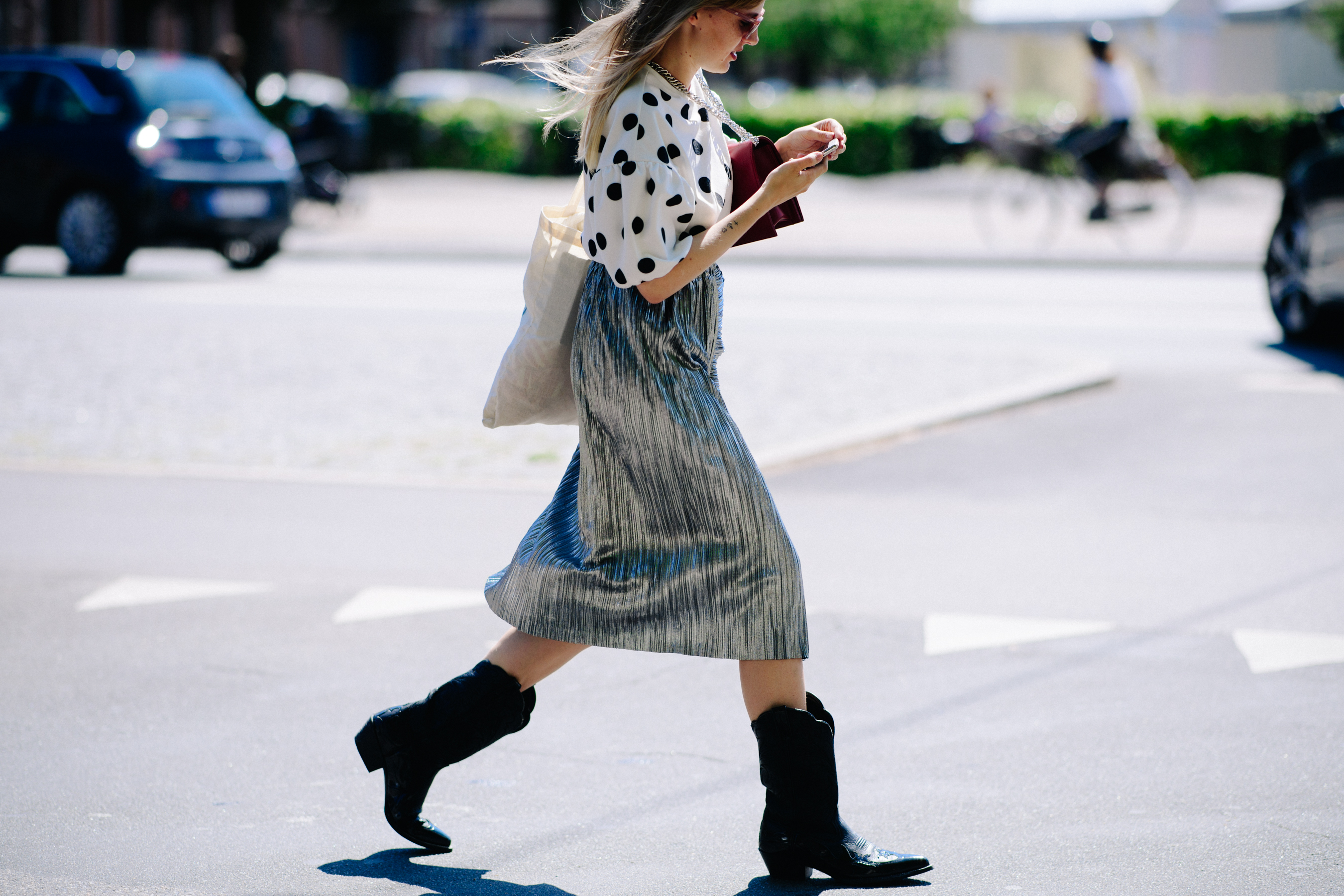 Woman wearing cowboy boots and silver skirt