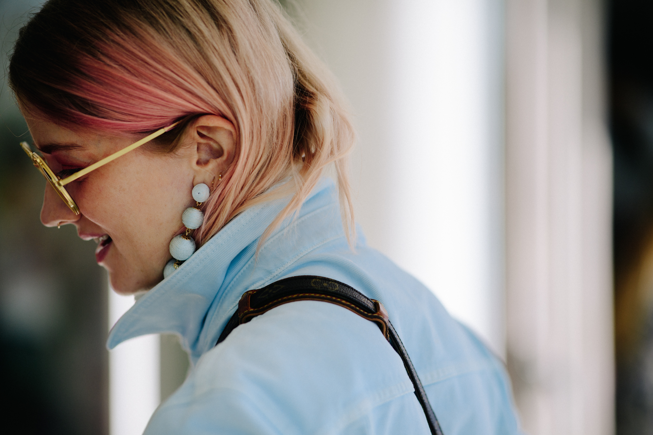 Woman with pink hair and earrings