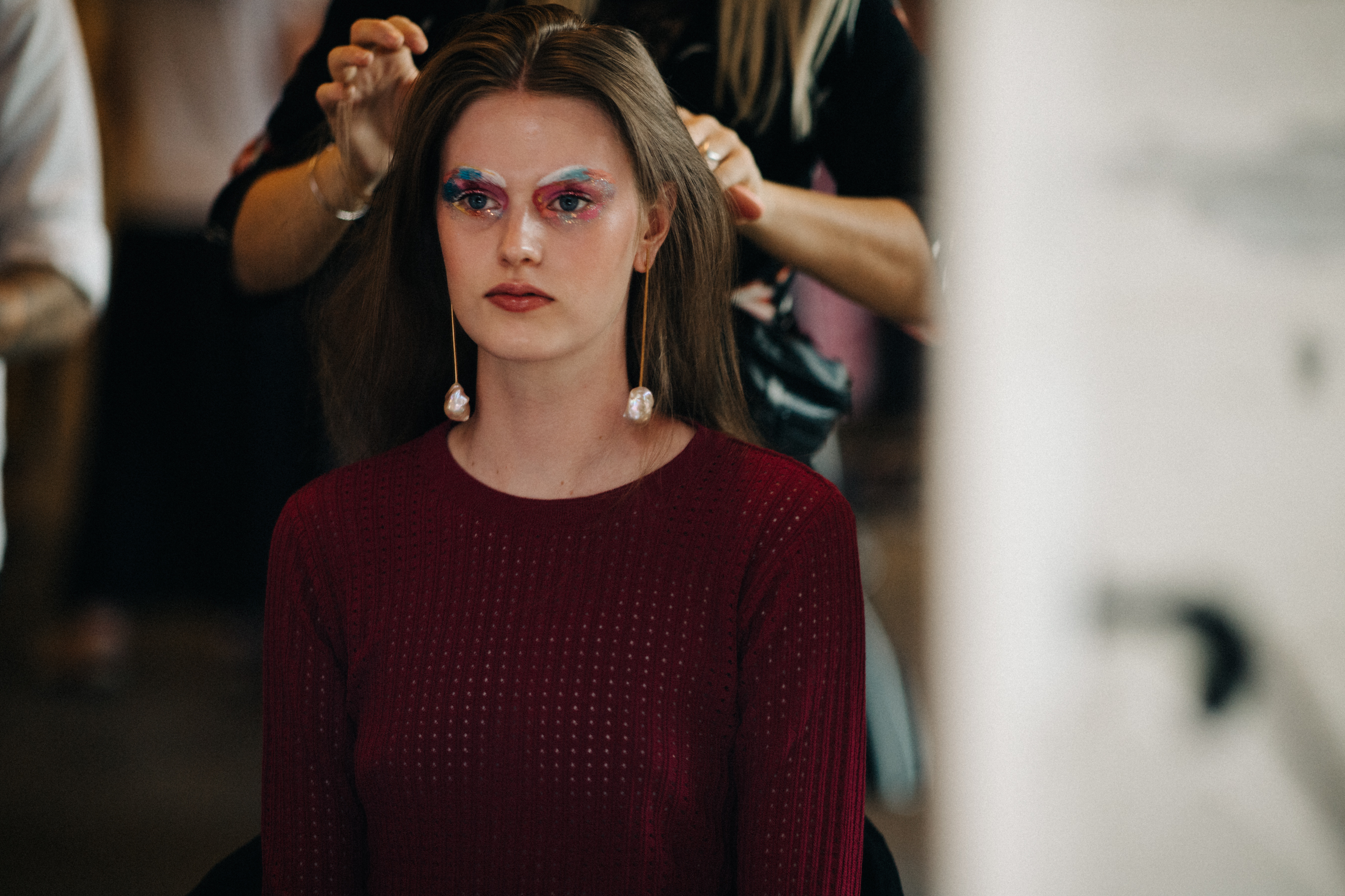Model getting colourful make up done