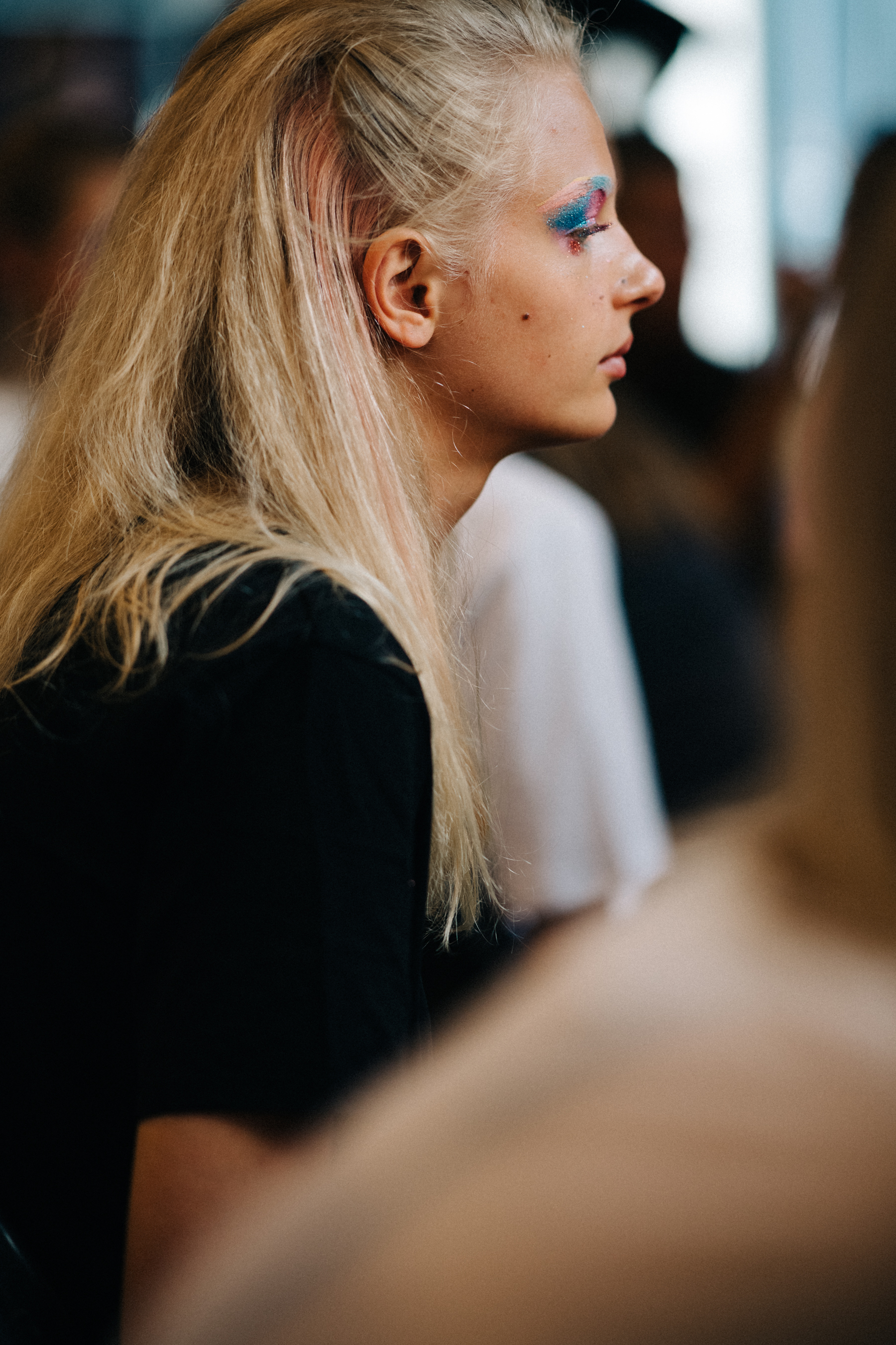 Model getting colourful make up done
