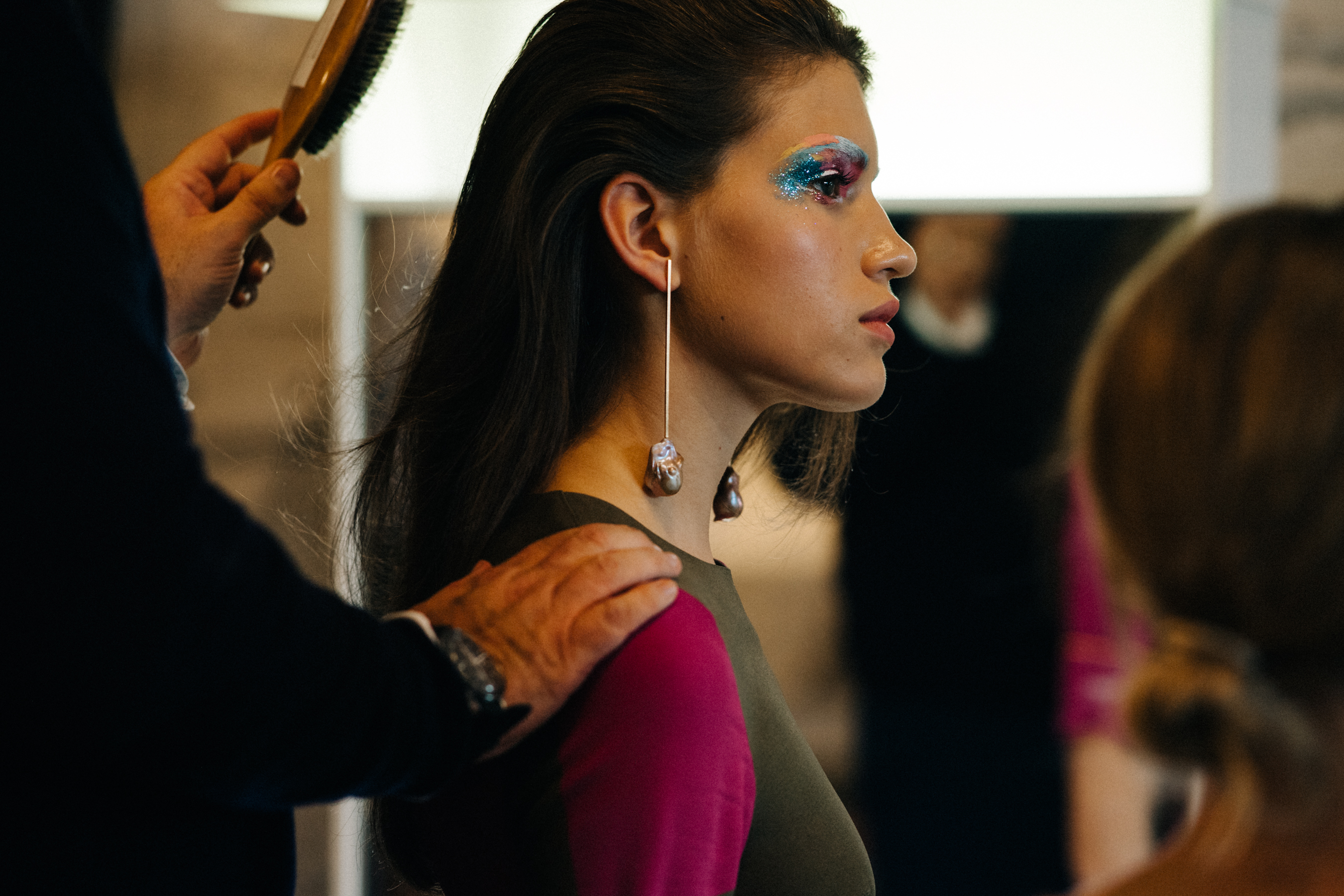 Model getting colourful make up done