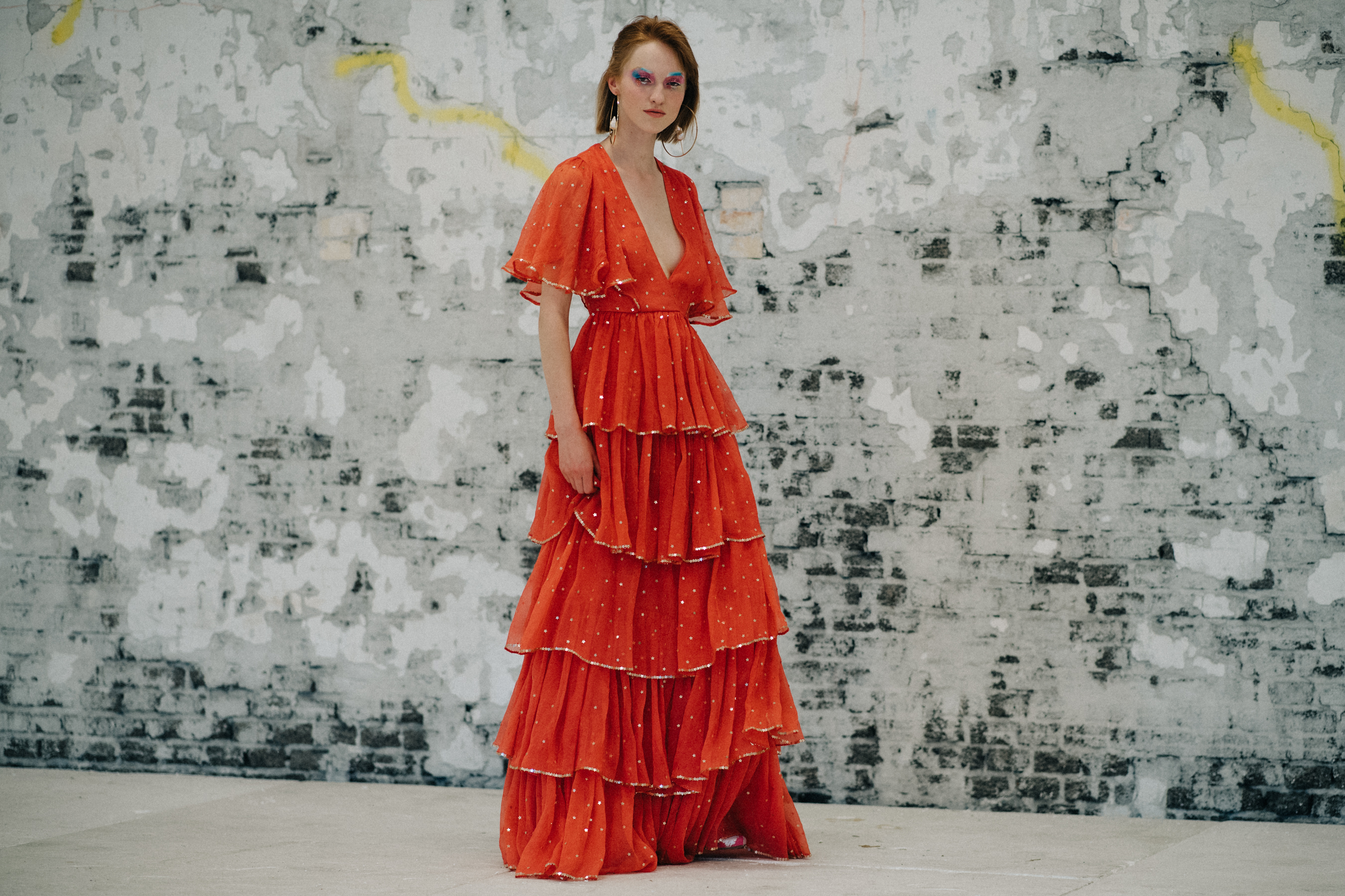 Mopdel wearing long red dress