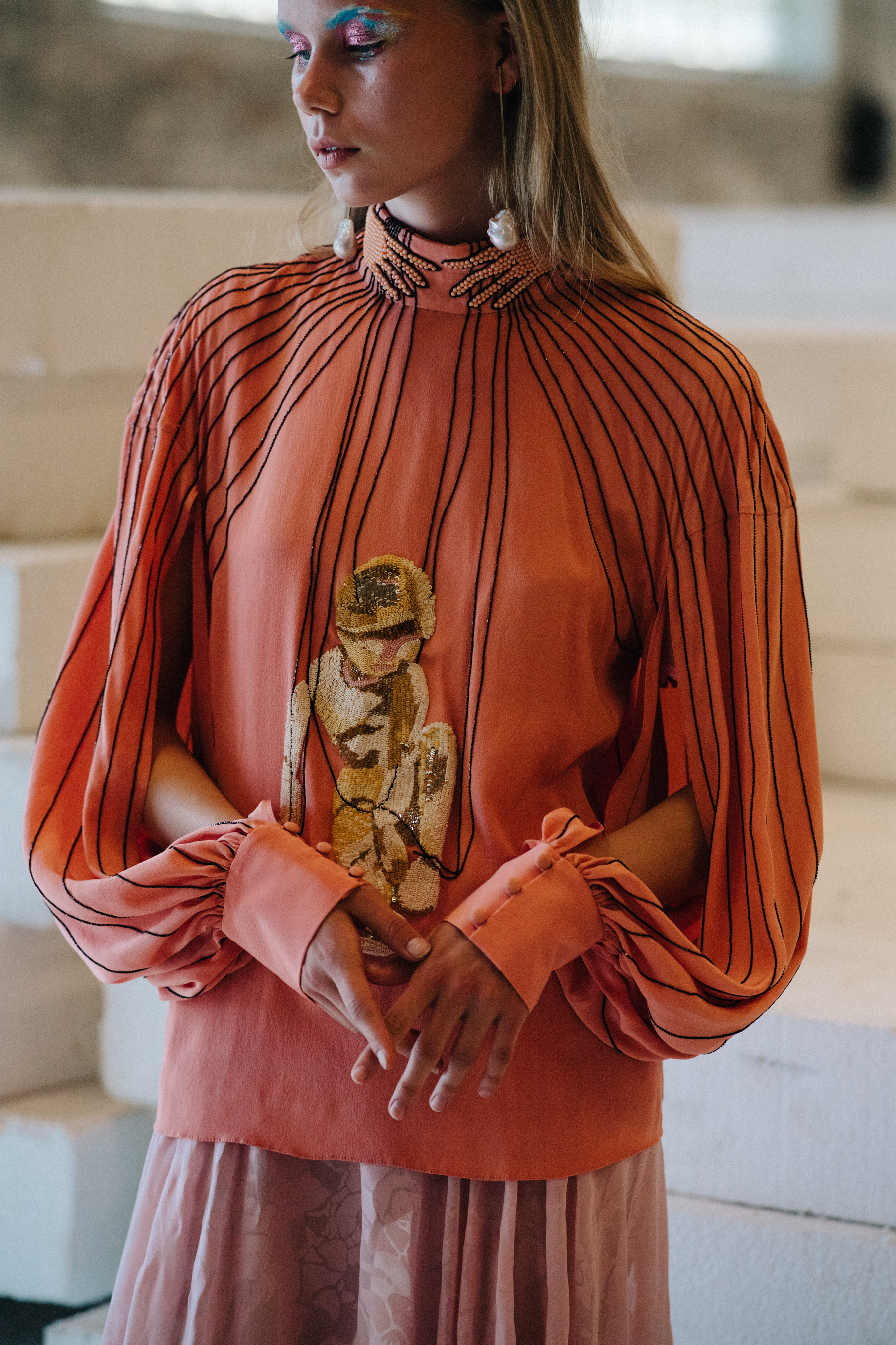Model wearing peach dress