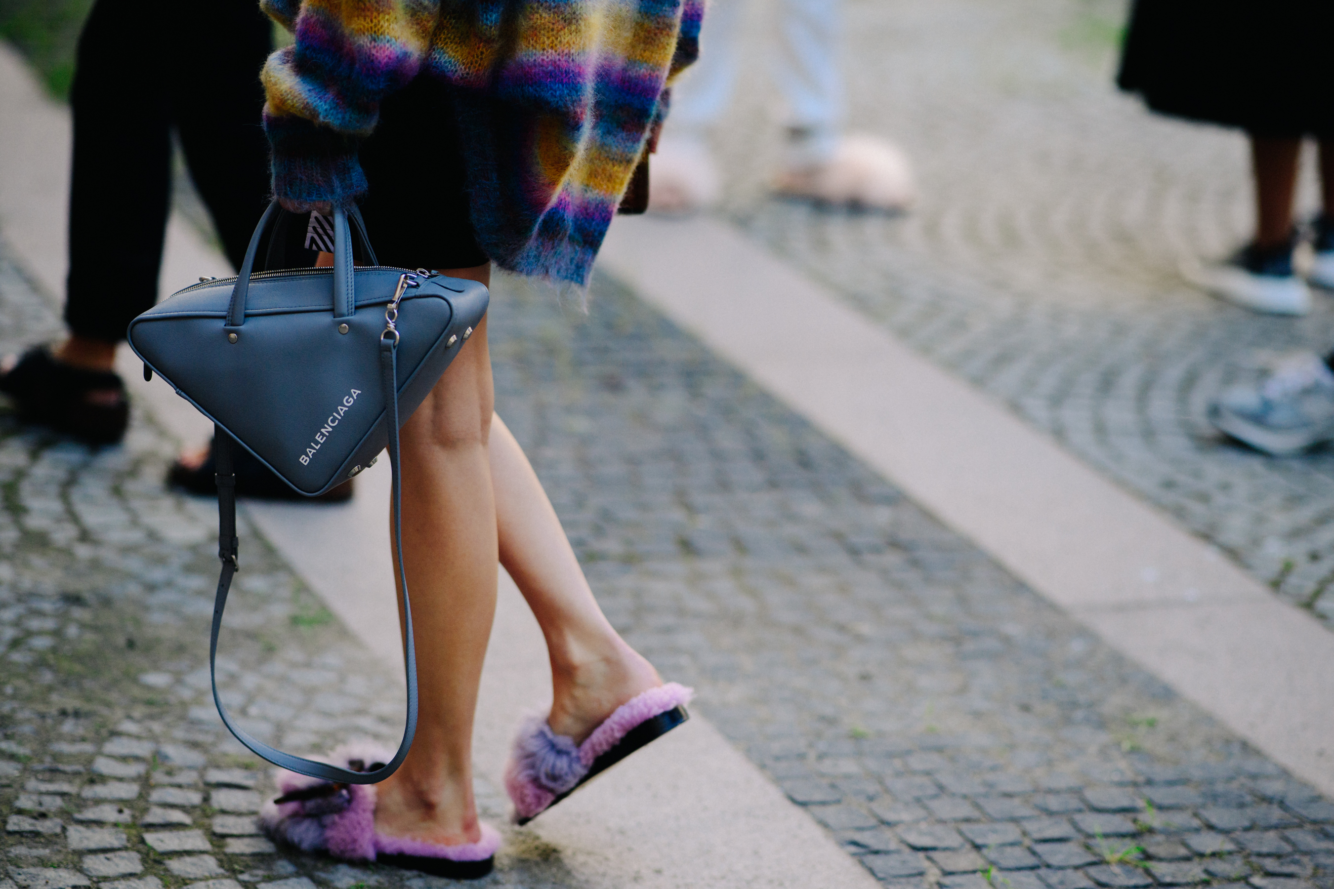 Woman with triangular Balenciaga bag