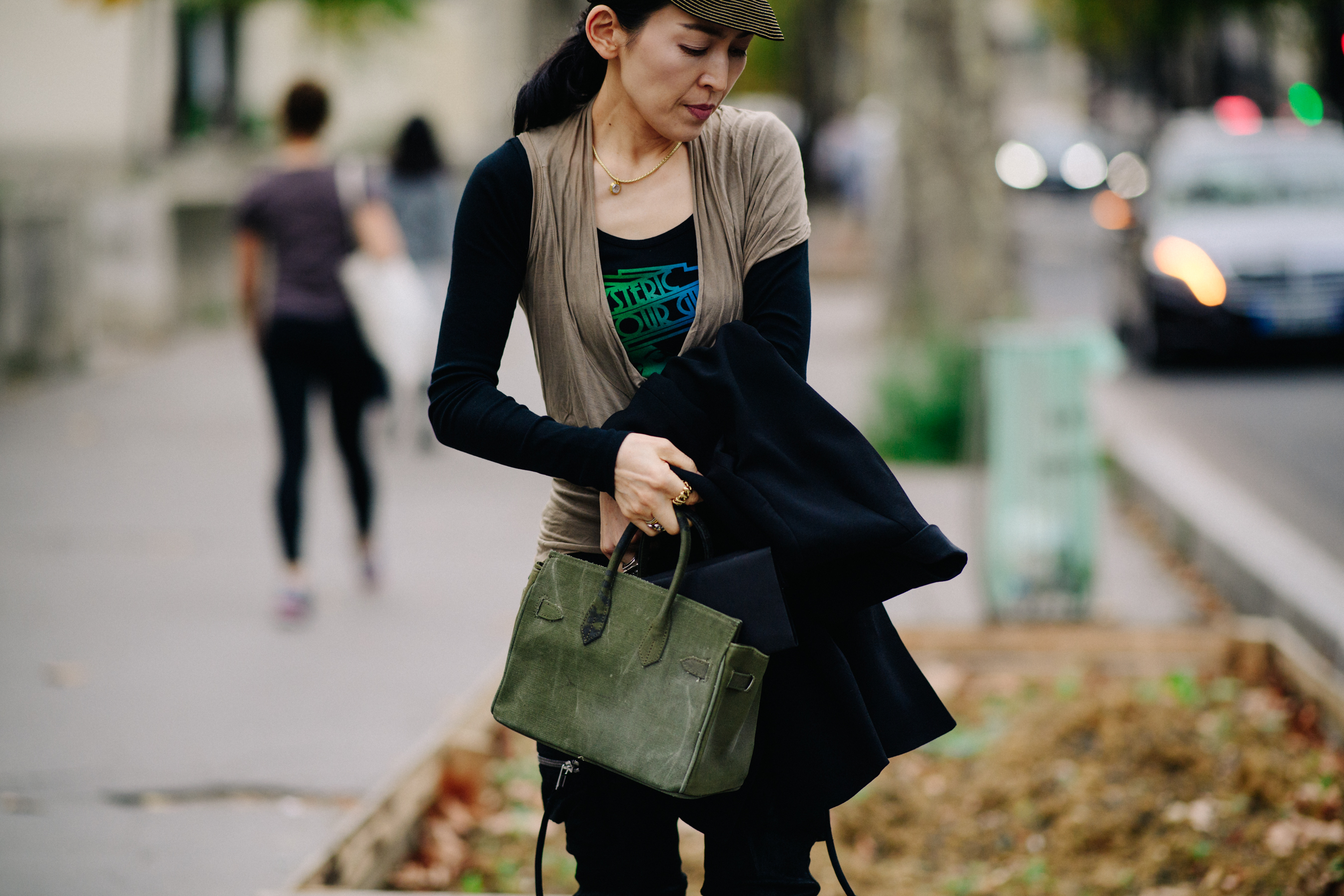 Woman wearing green hand bag