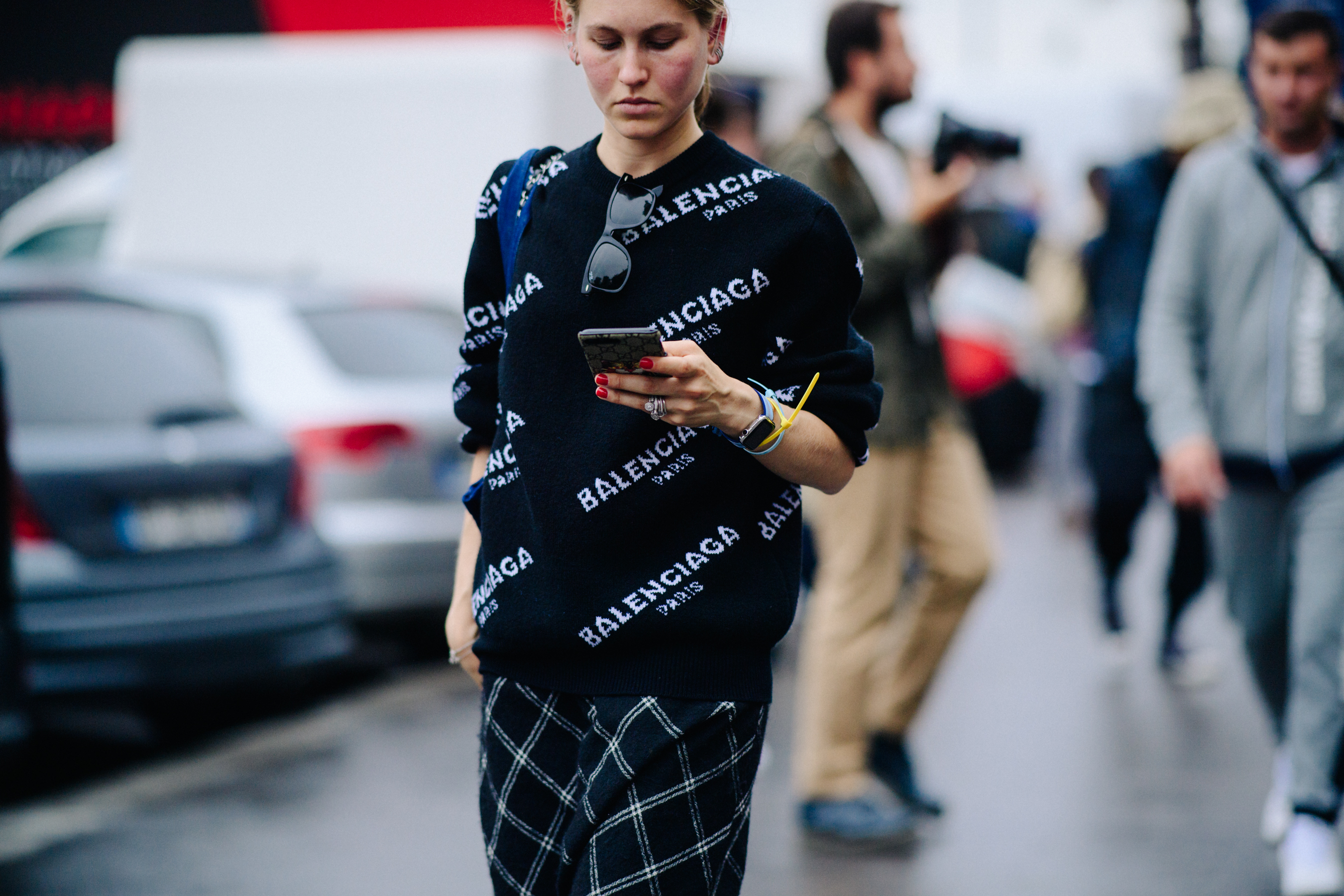 Woman wearing sweater with Balenciaga logo