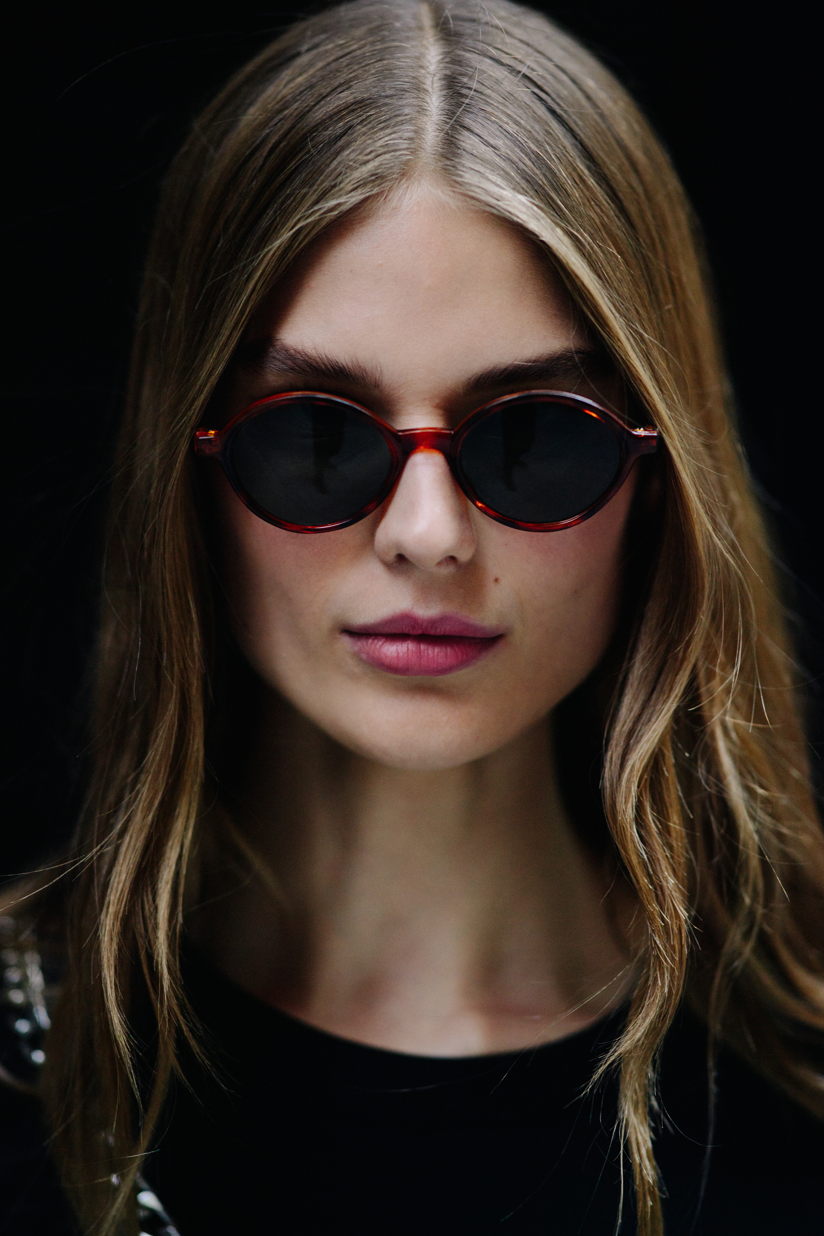 Model wearing all black and sunglasses