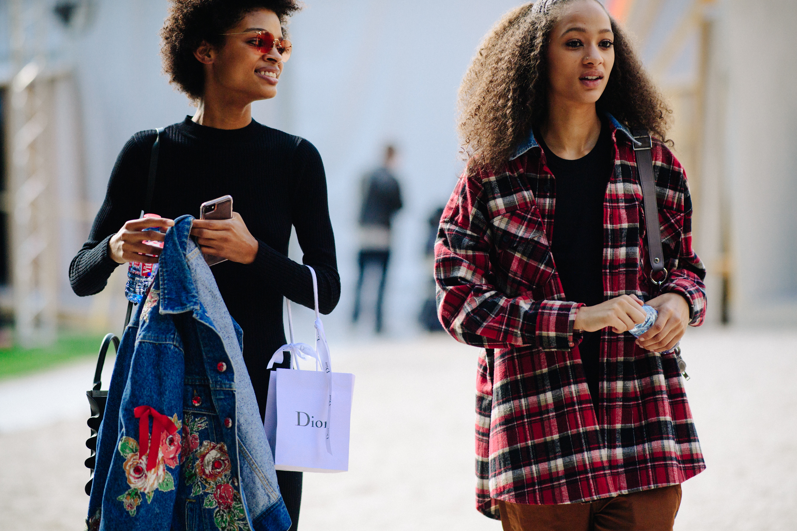 Two models with curly hair after a show