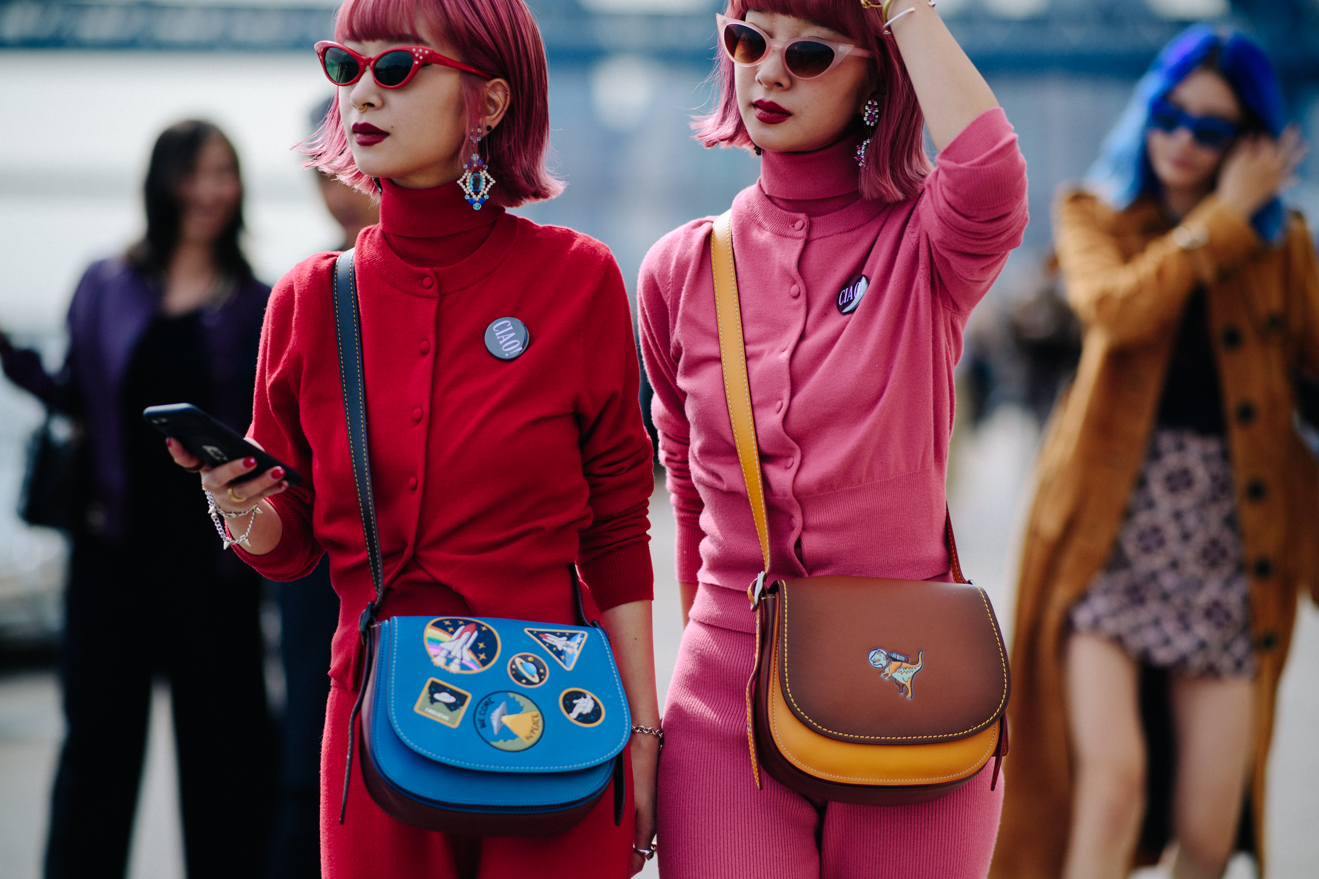 Two women with identical pink hair