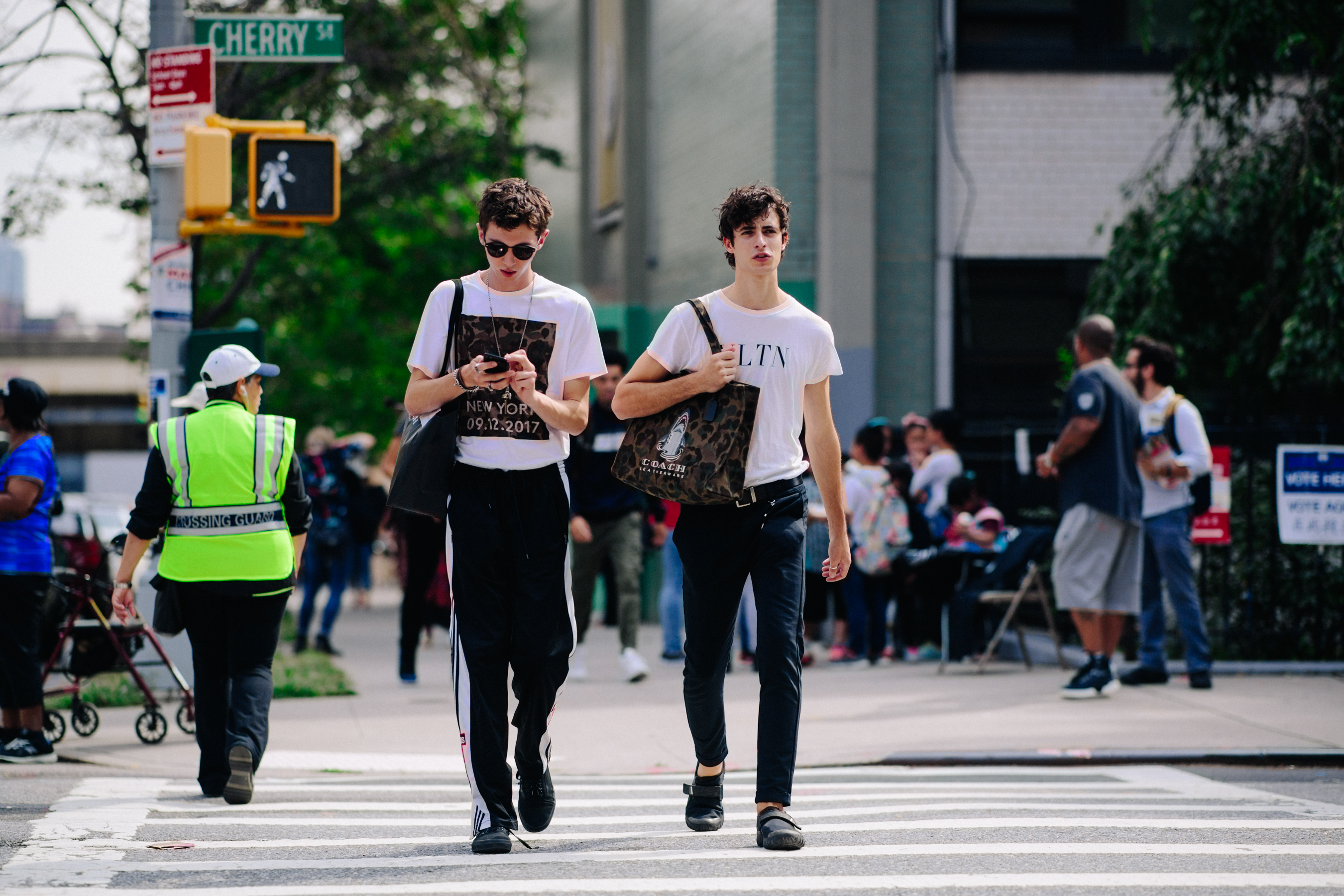 Two male models wearing white t-shirts