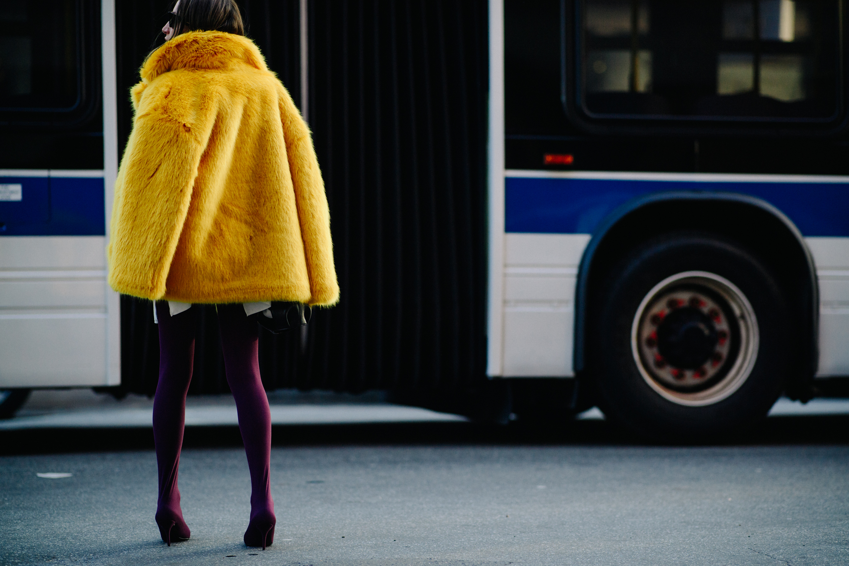 Stylist wearing yellow faux fur coat