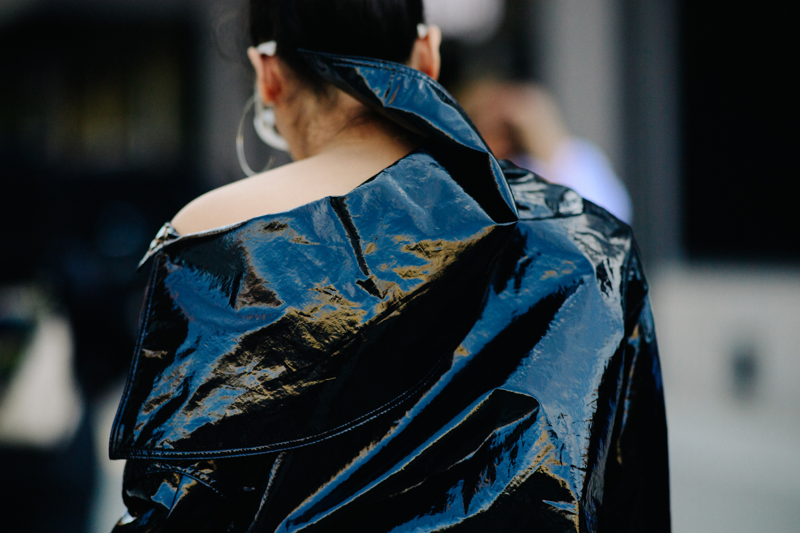 Woman wearing shiny leather coat