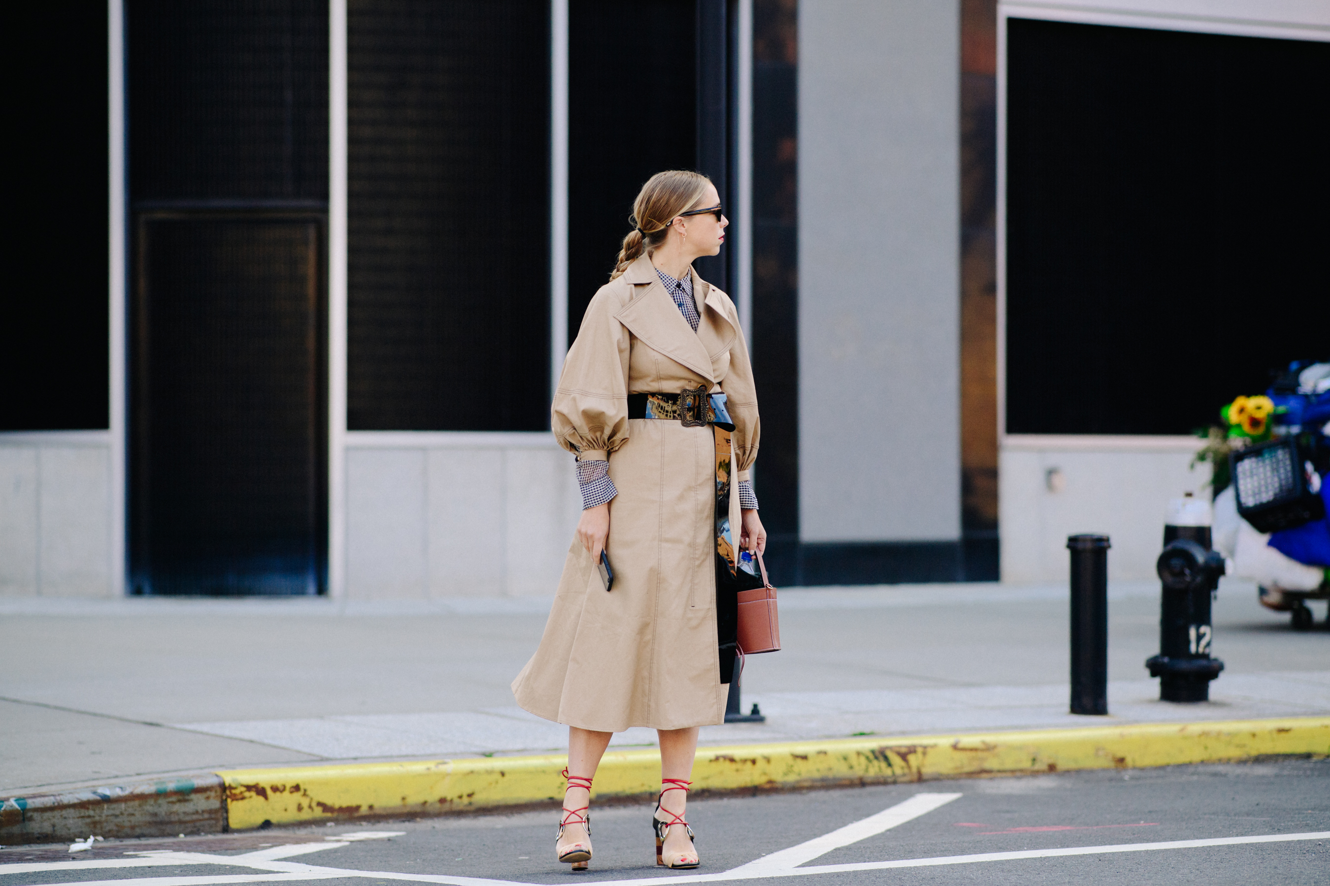 Woman wearing long beige trench dress
