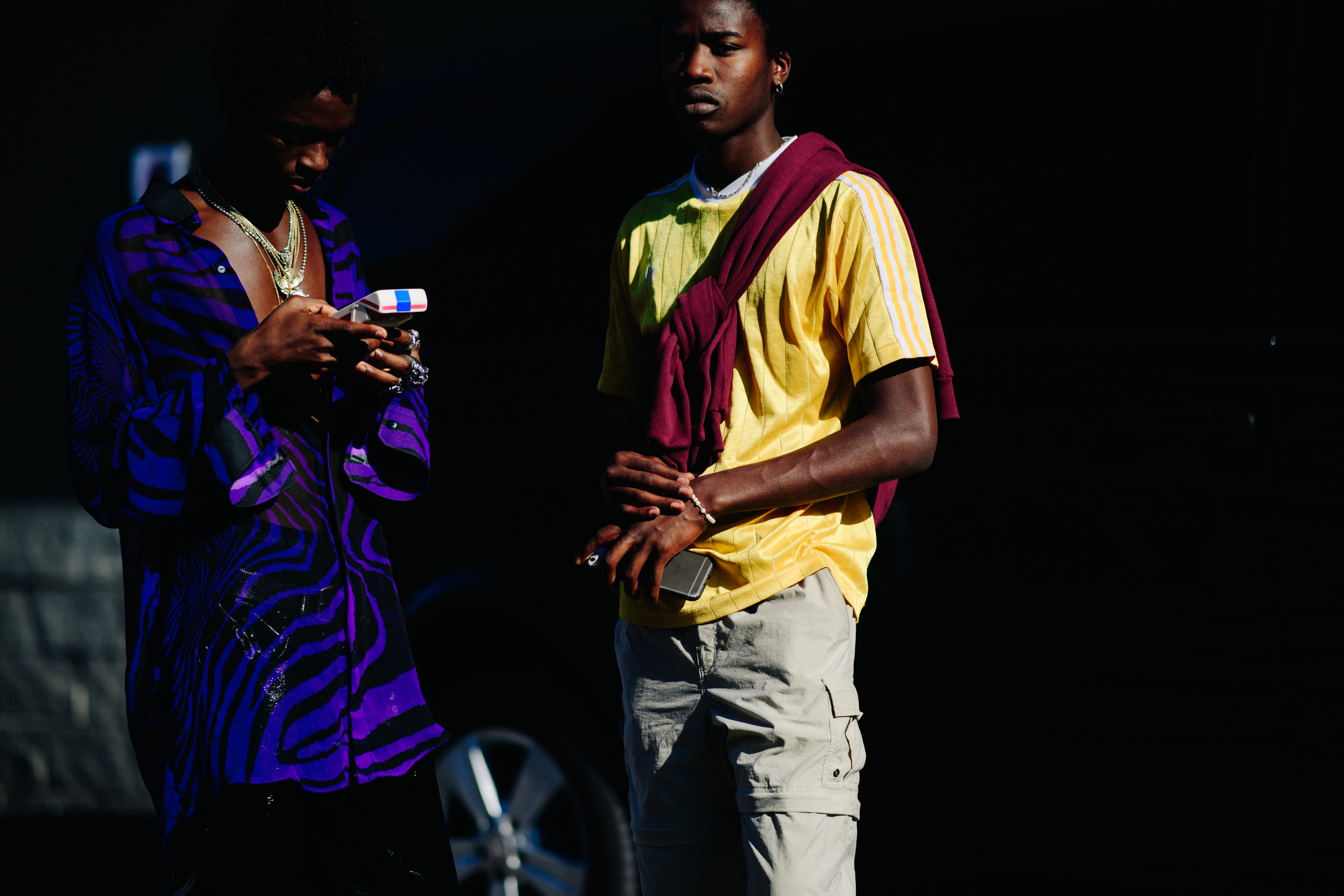 Two black men in colourful outfits
