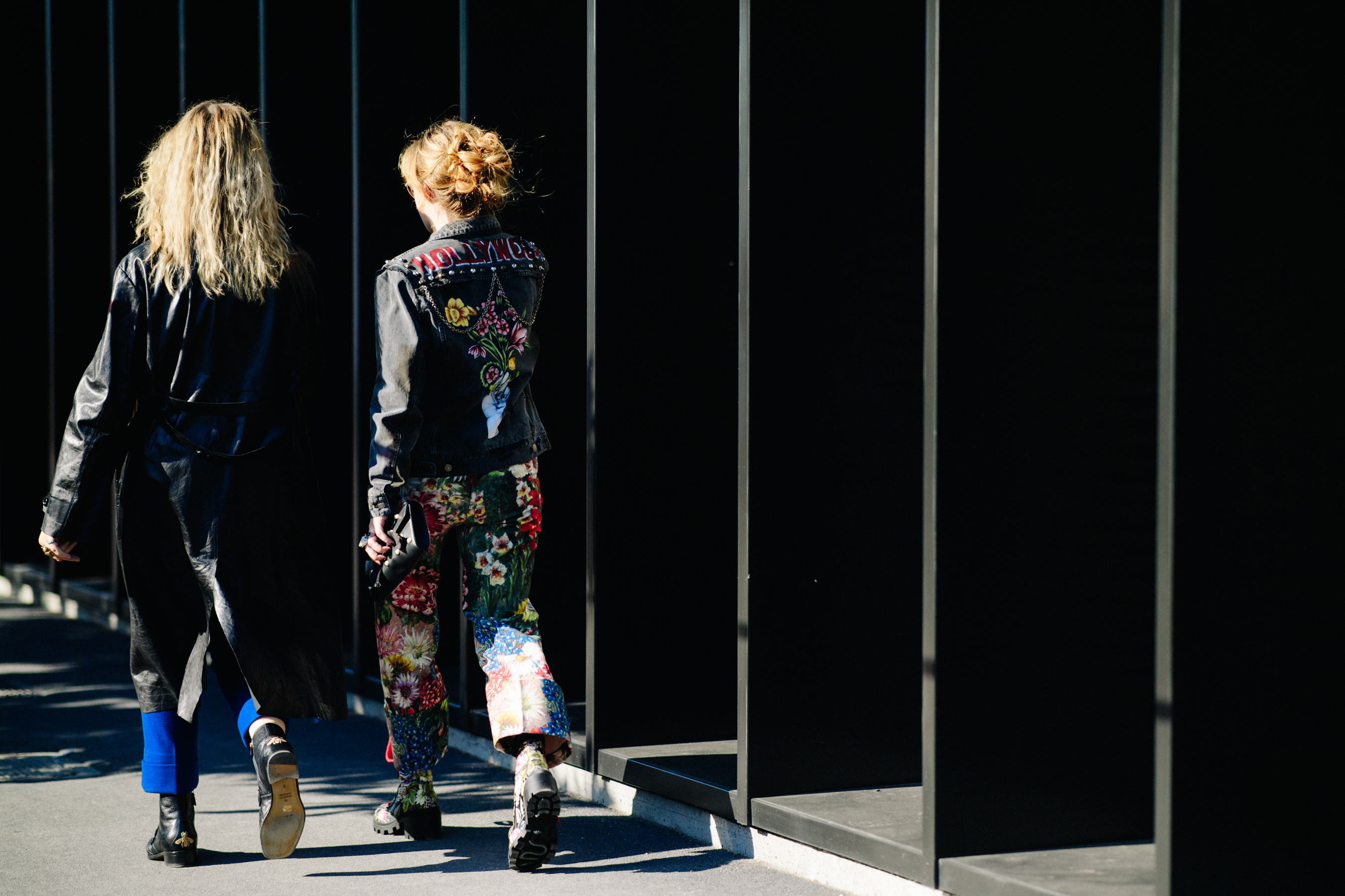Back of women walking in black outfits