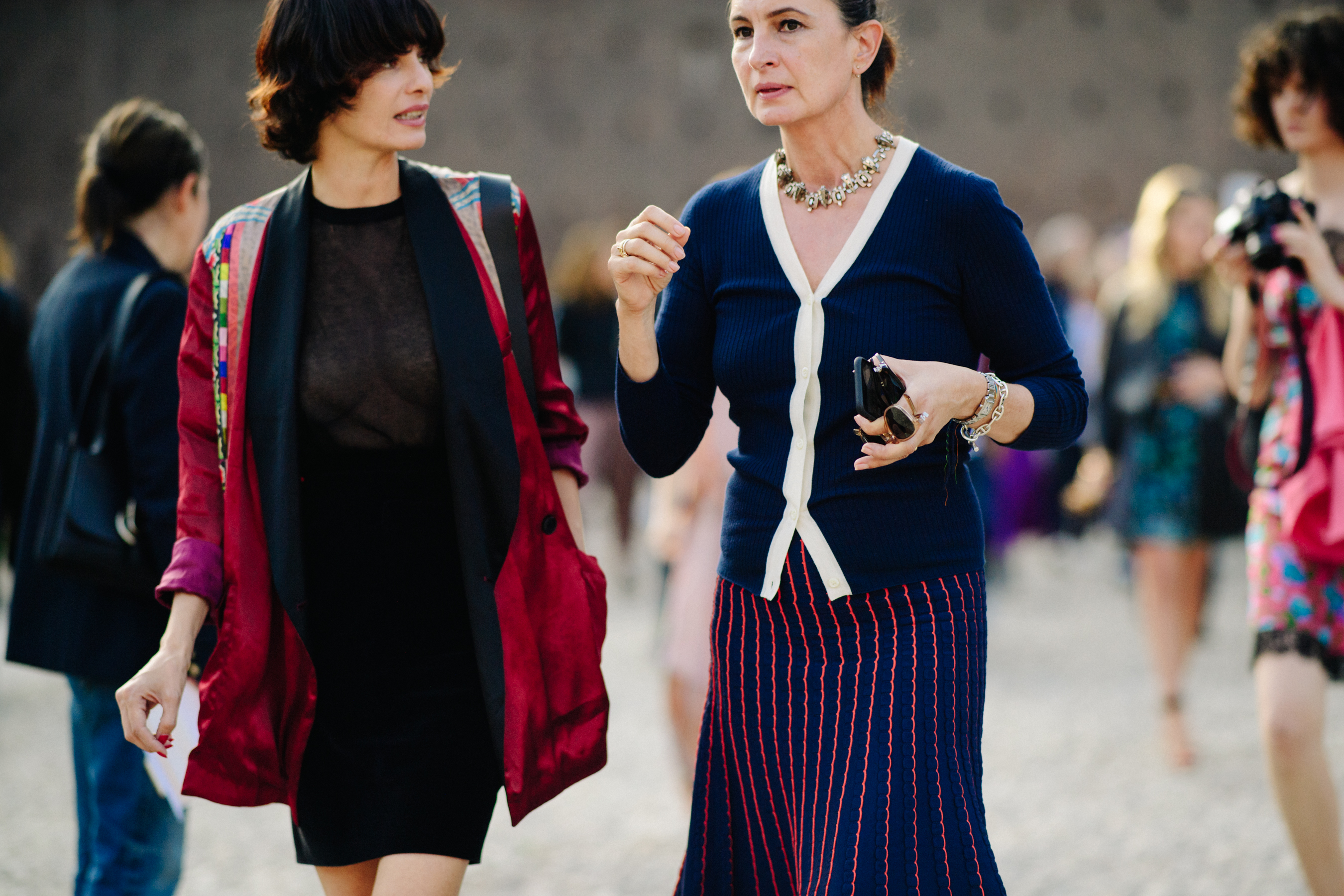 Two women walking in colourful outfits