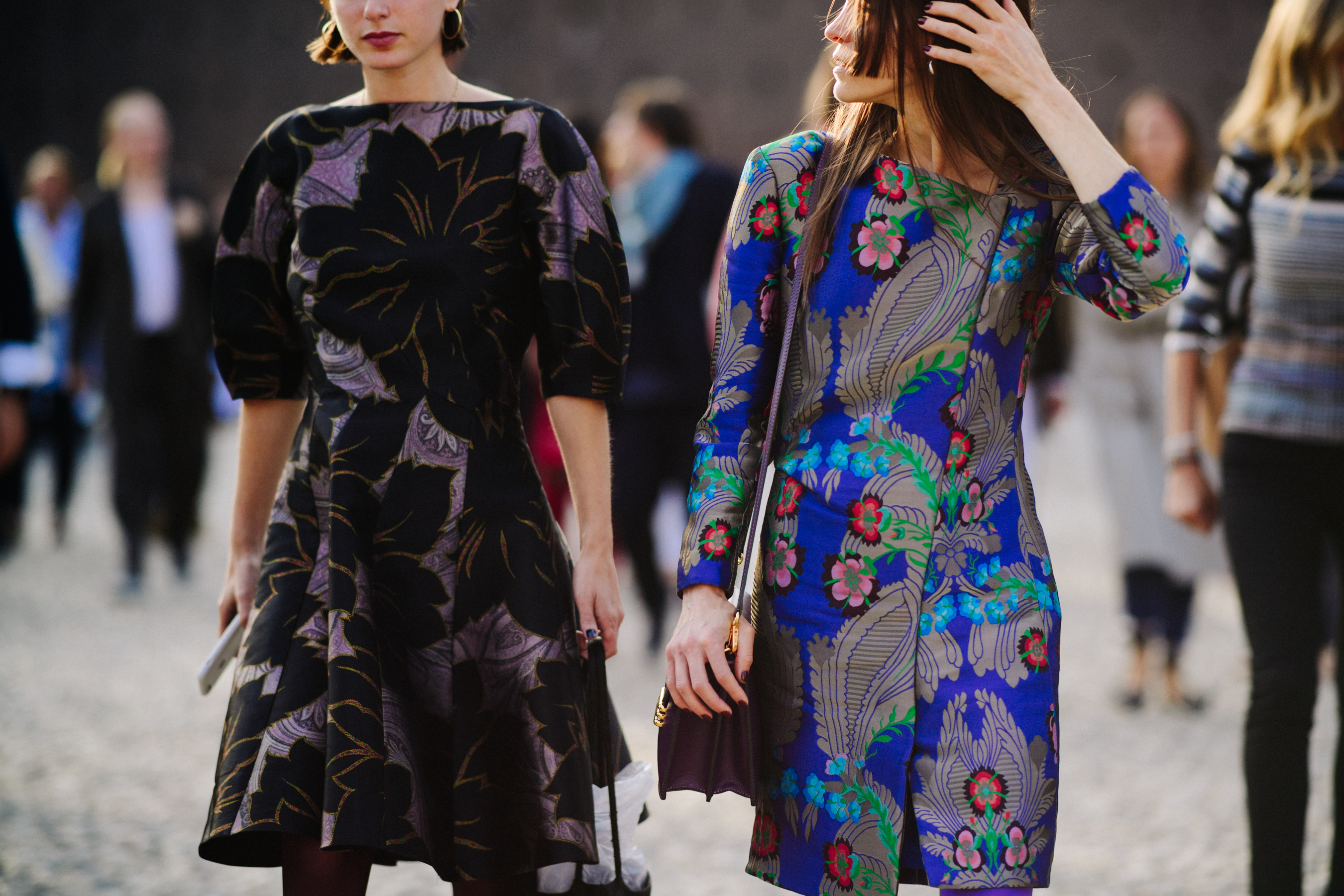 Two women wearing floral outfits
