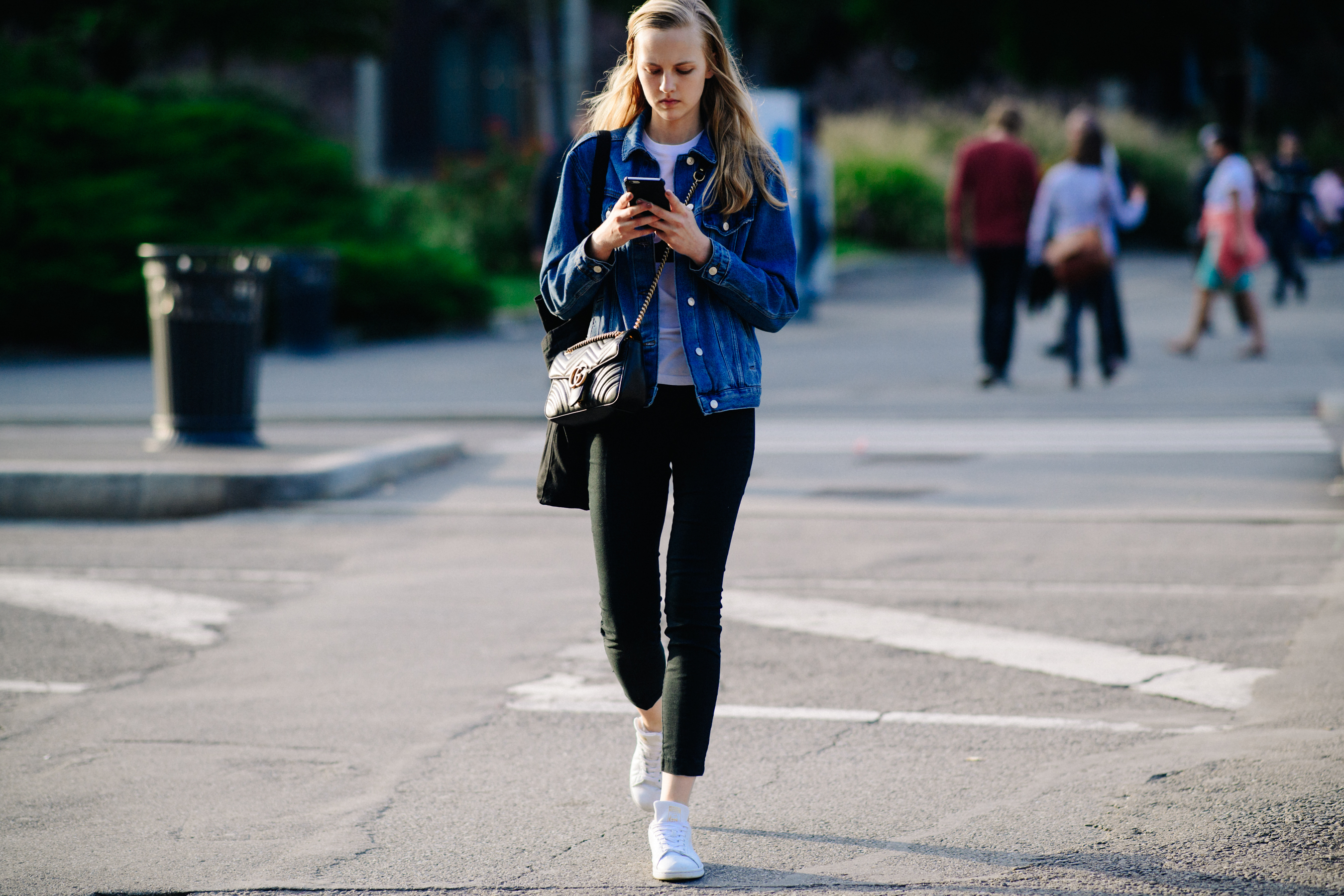 Model walking in denim jacket