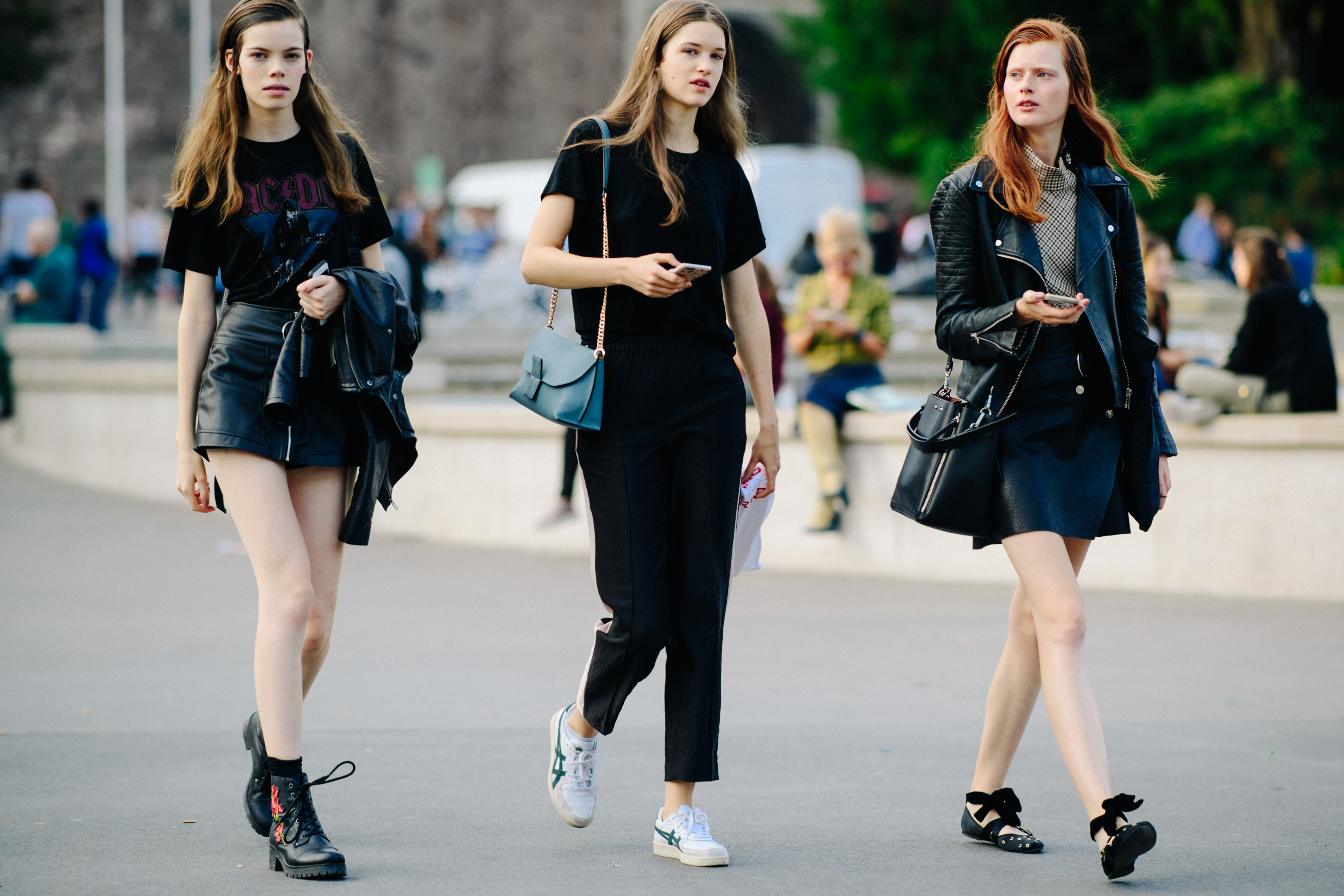 Three models walking in black outfits
