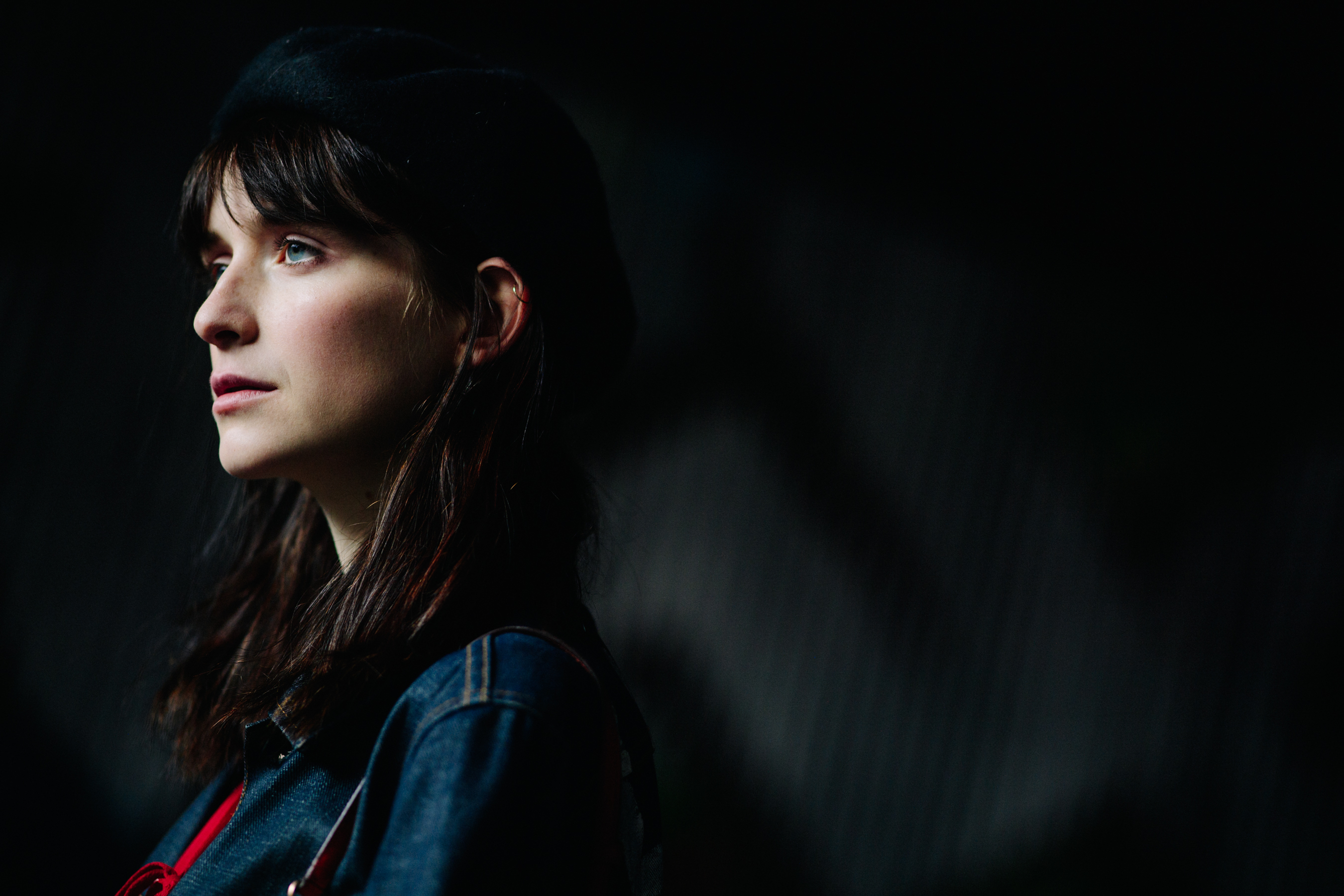 Model wearing black beret and denim jacket