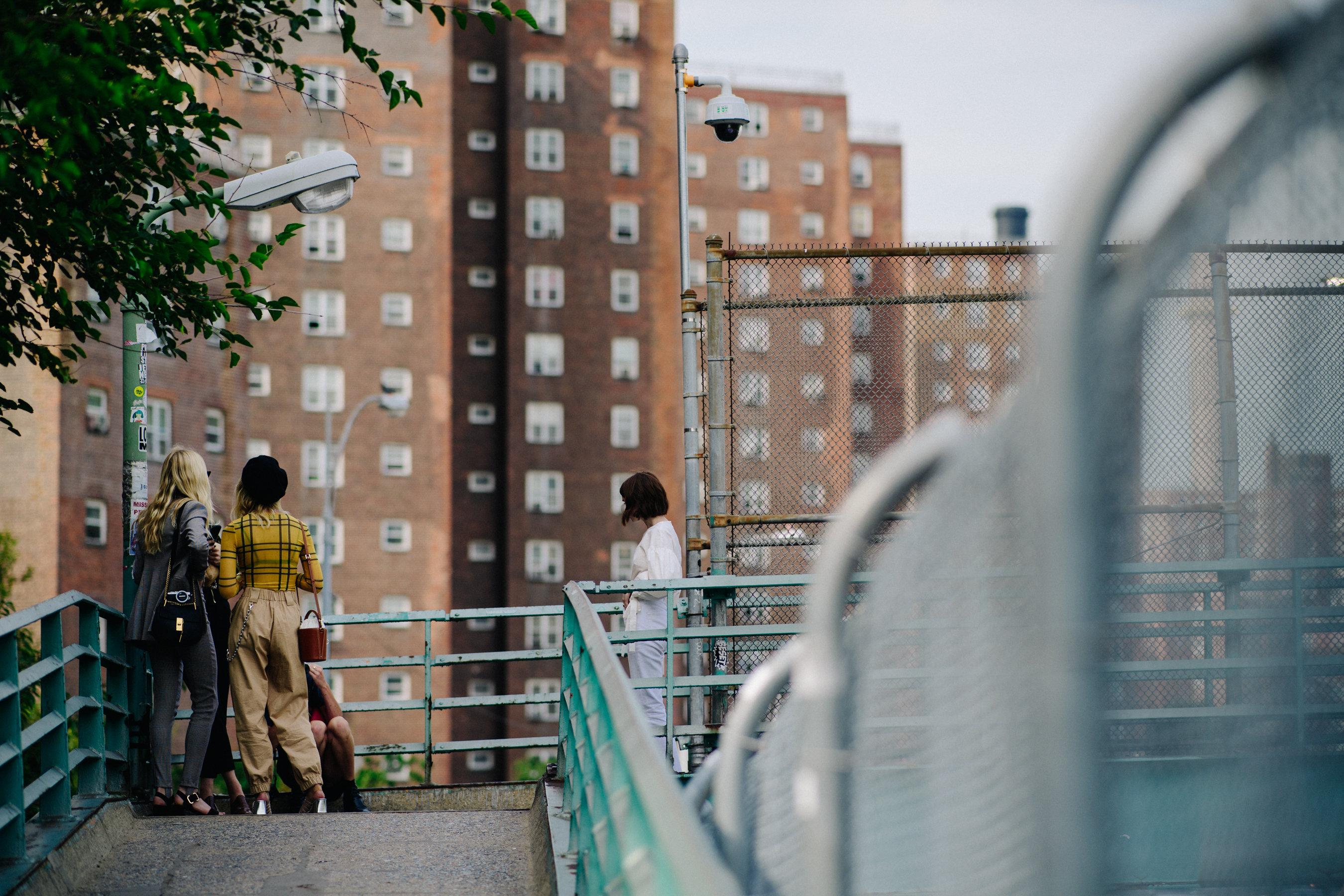 Group of women standing on a bridge