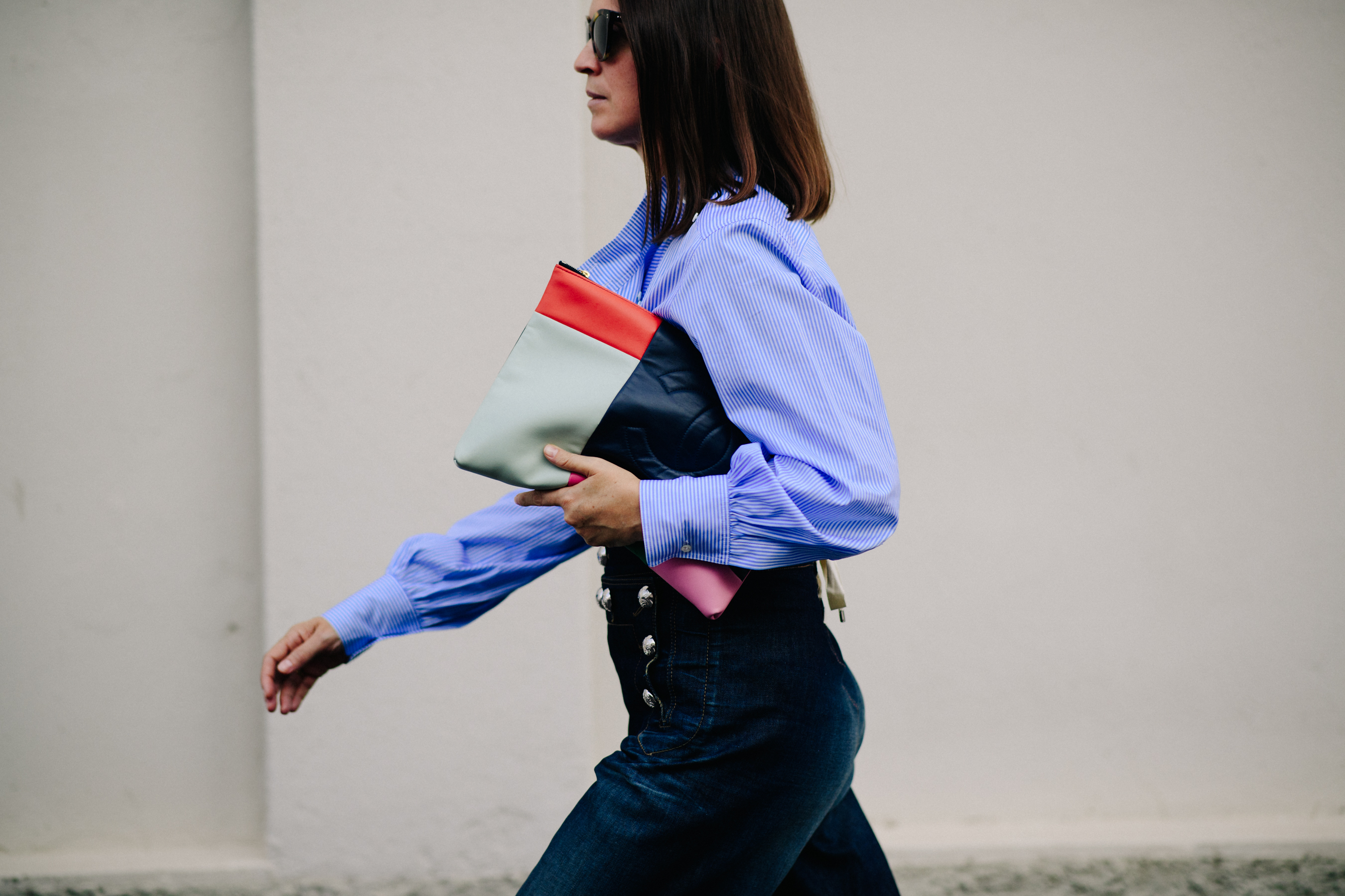 Woman in striped shirt holding chanel bag