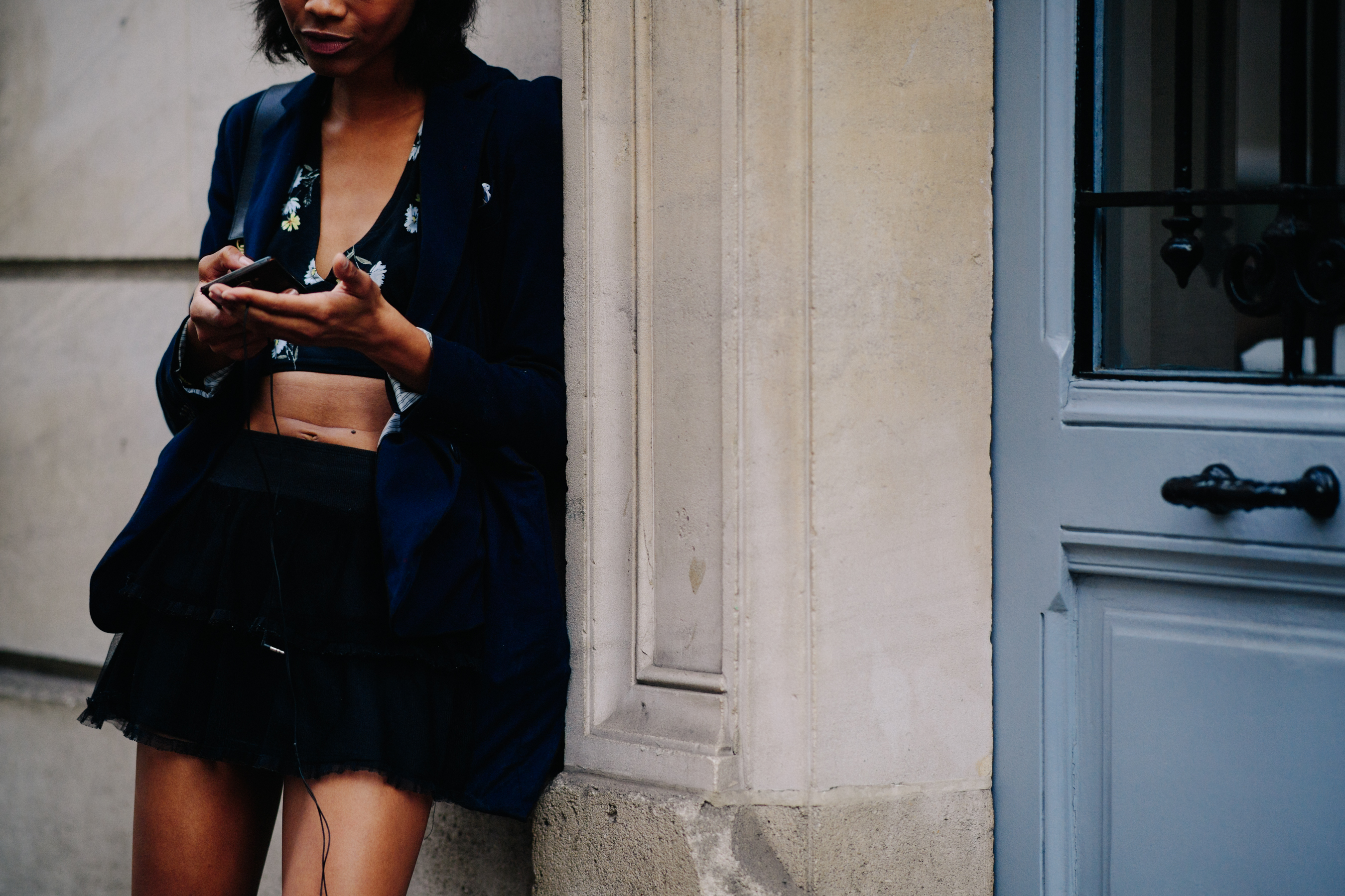 Model wearing black skirt after a show