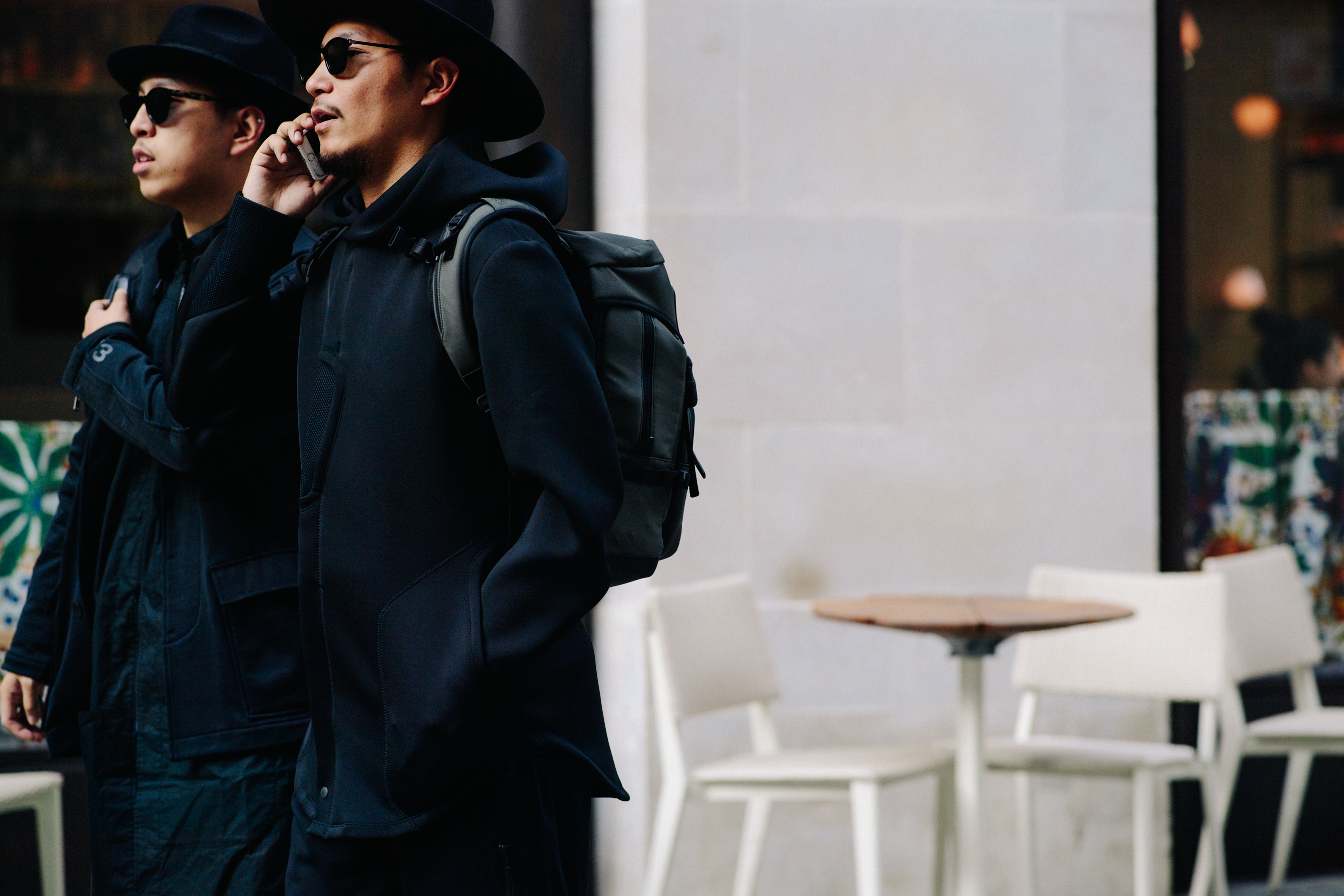 Two men wearing black hats