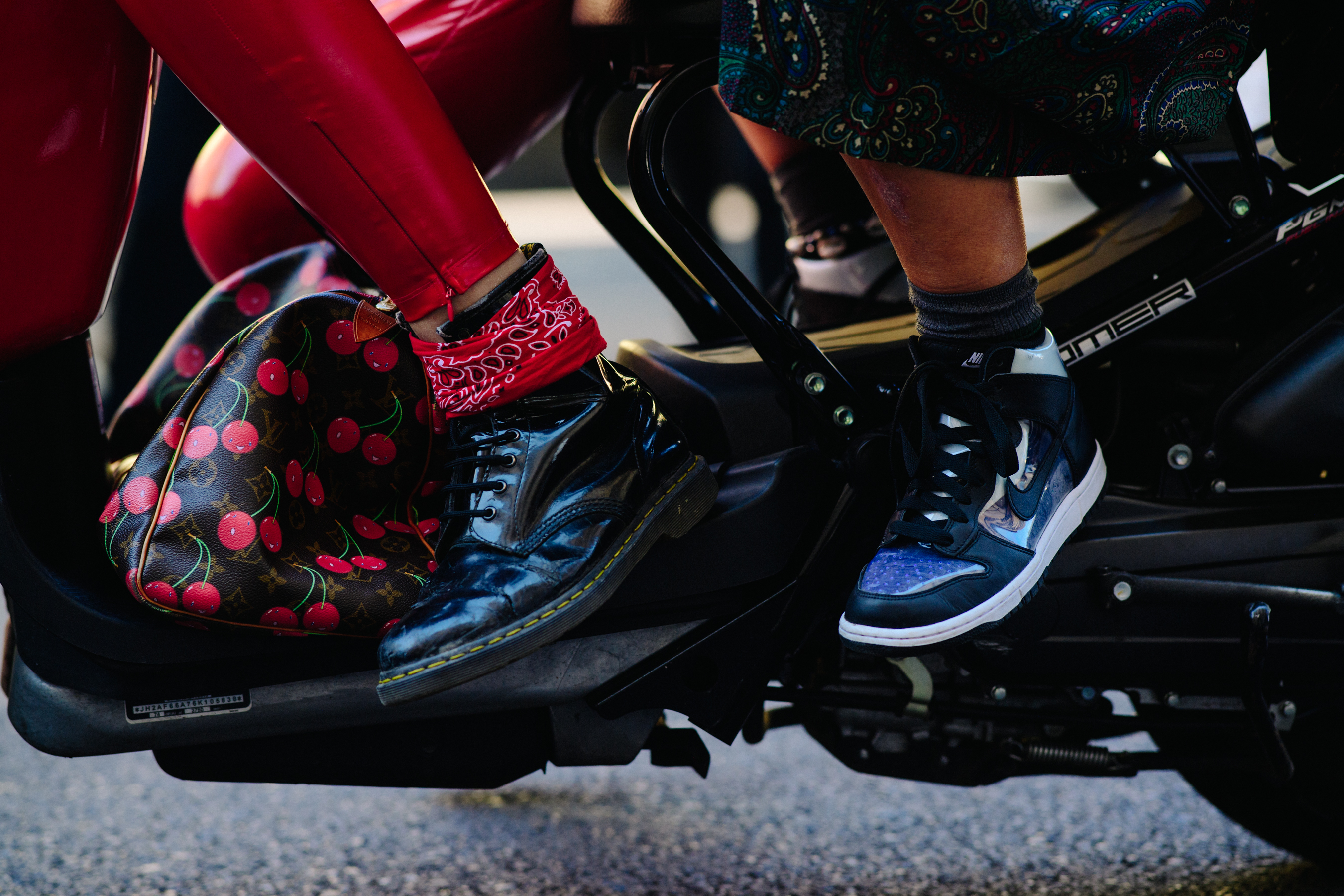 Closeup of peoples feet on a motorcycle