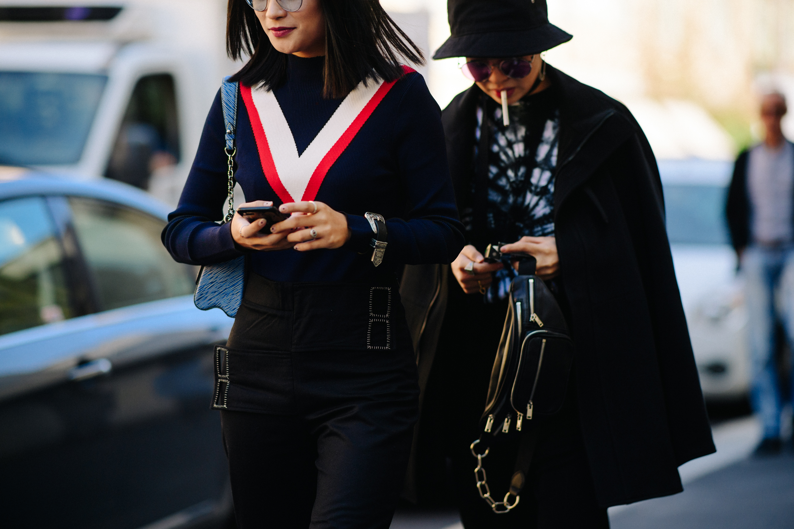 Two women in dark glasses and outfits
