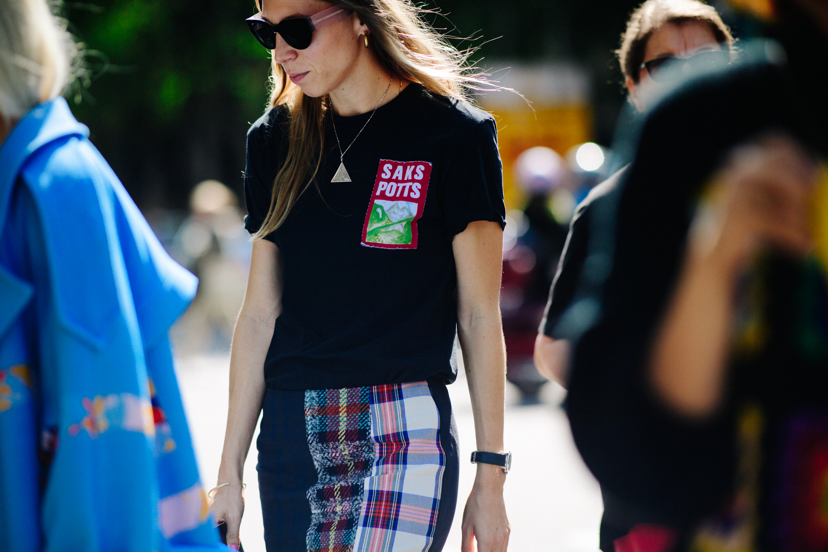 Woman walking in branded black tee shirt