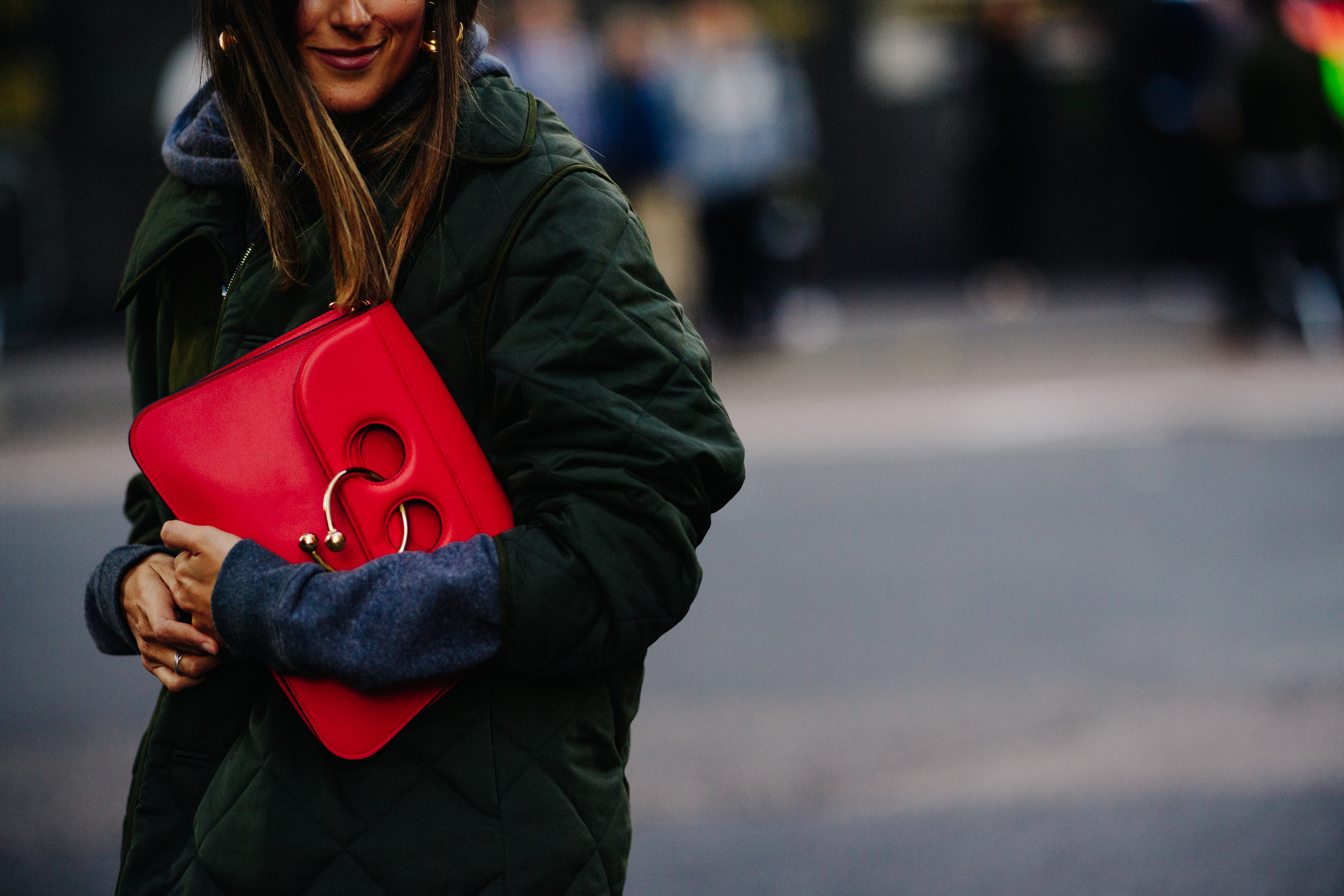 Woman wearing red J.W.Anderson bag