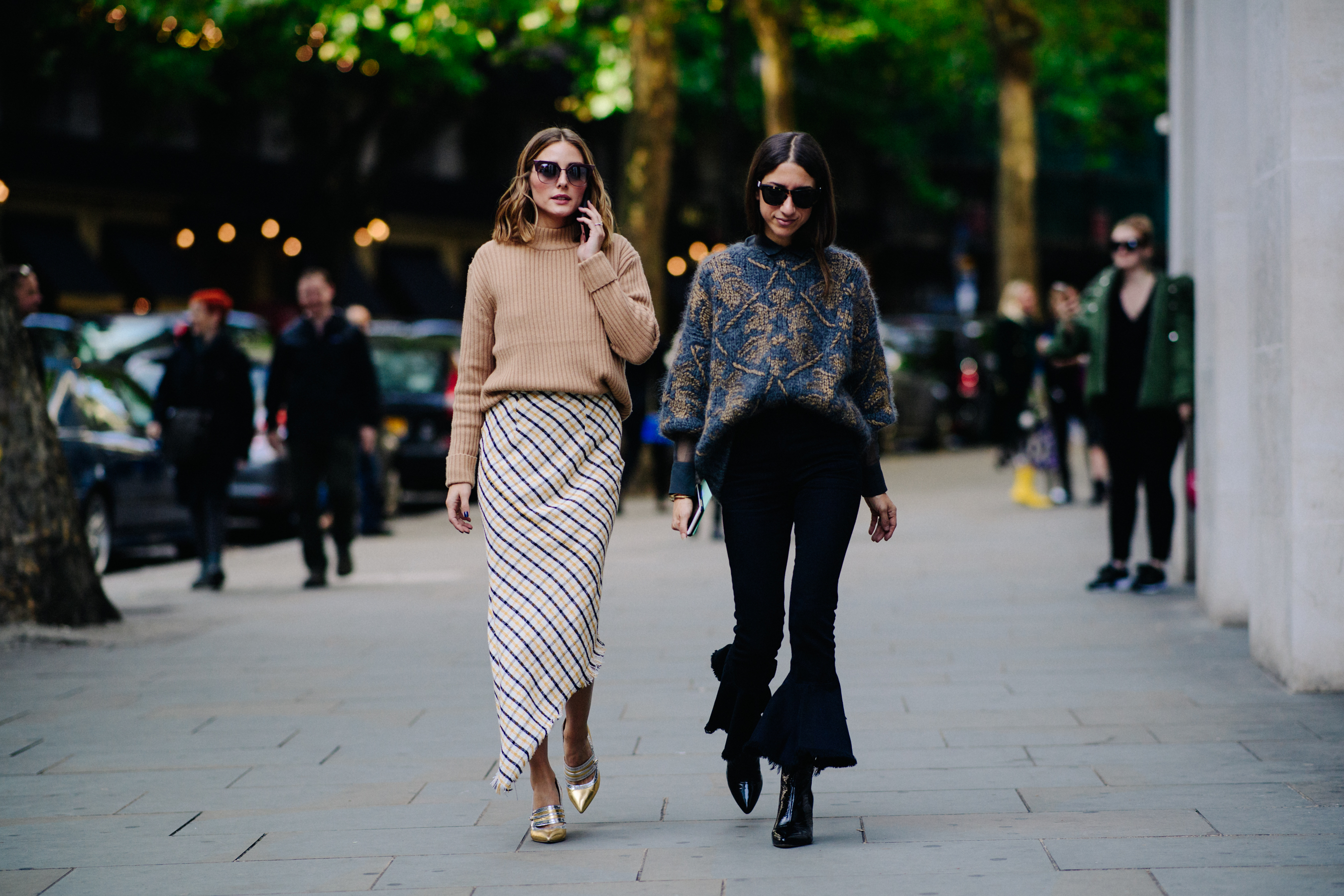 Two women wearing sweaters