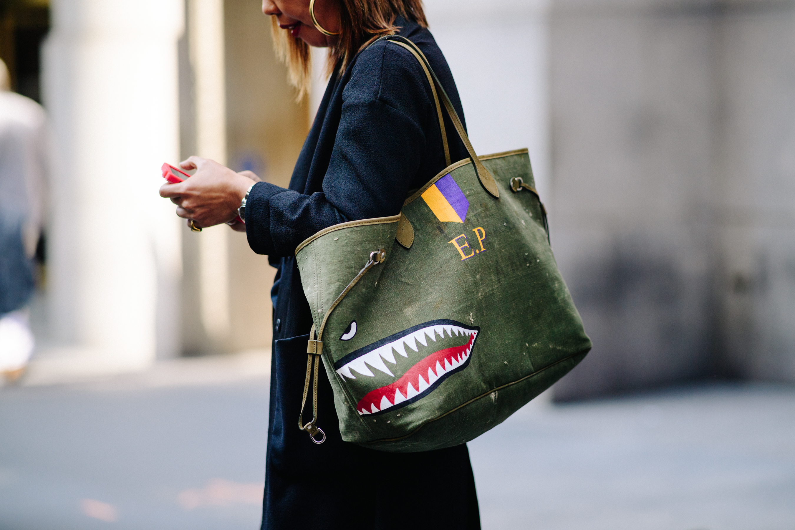 Woman holding big bag with graphic