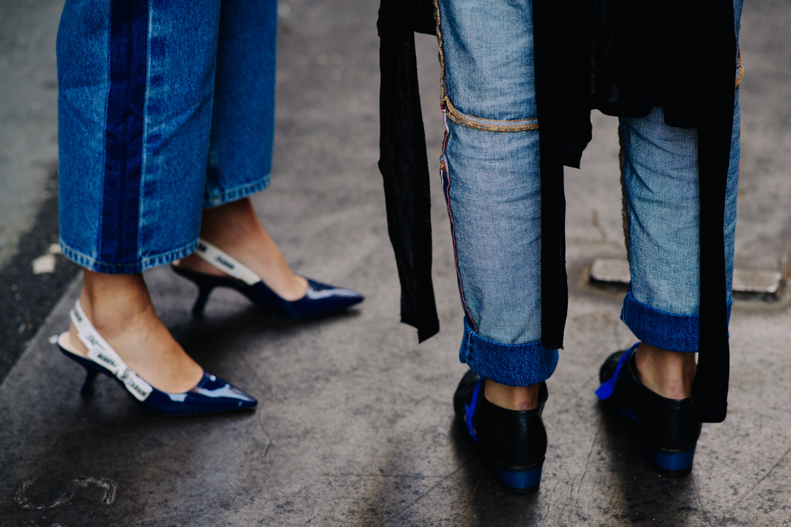Two women wearing denim and Dior shoes