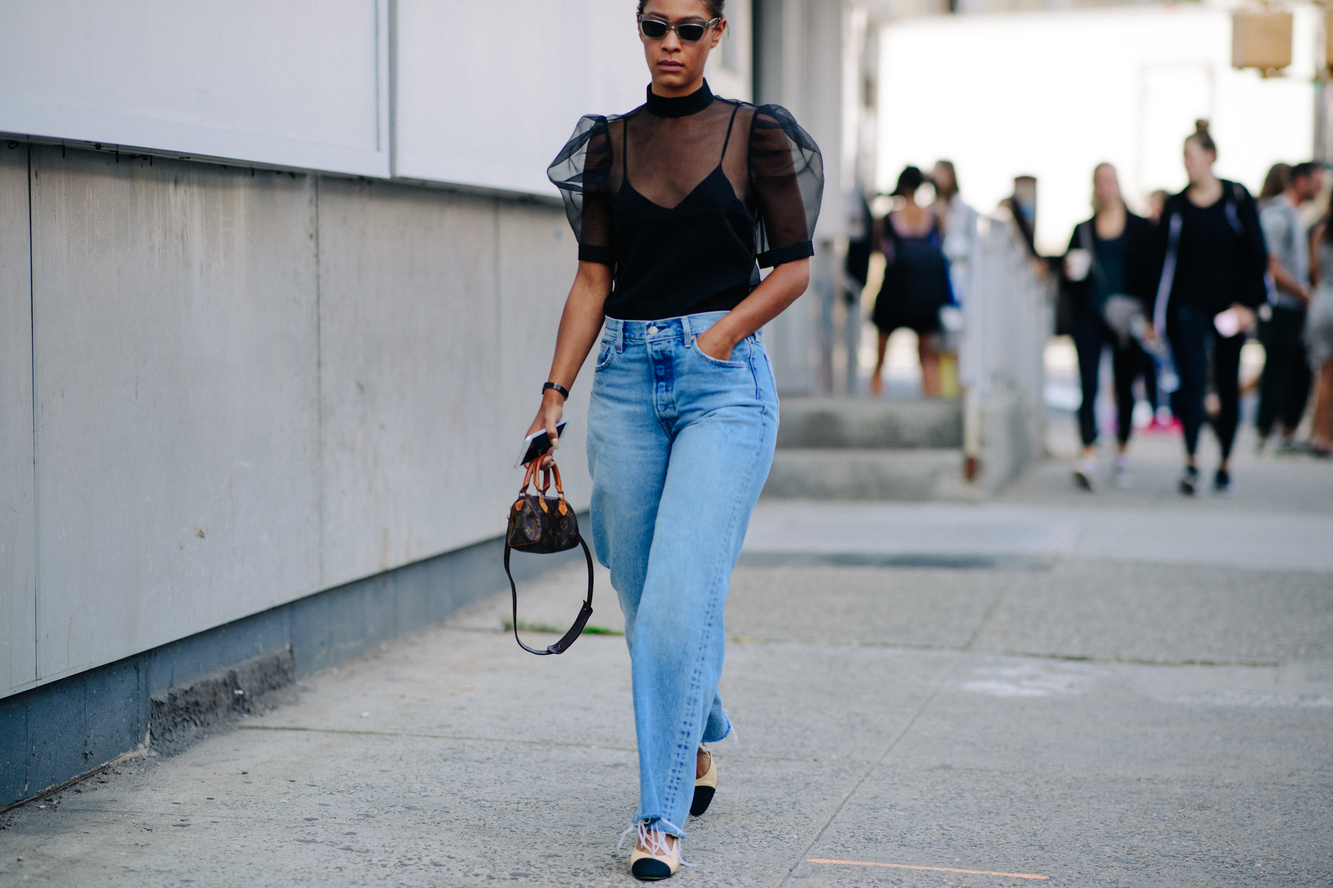 Woman wearing transparent top and jeans